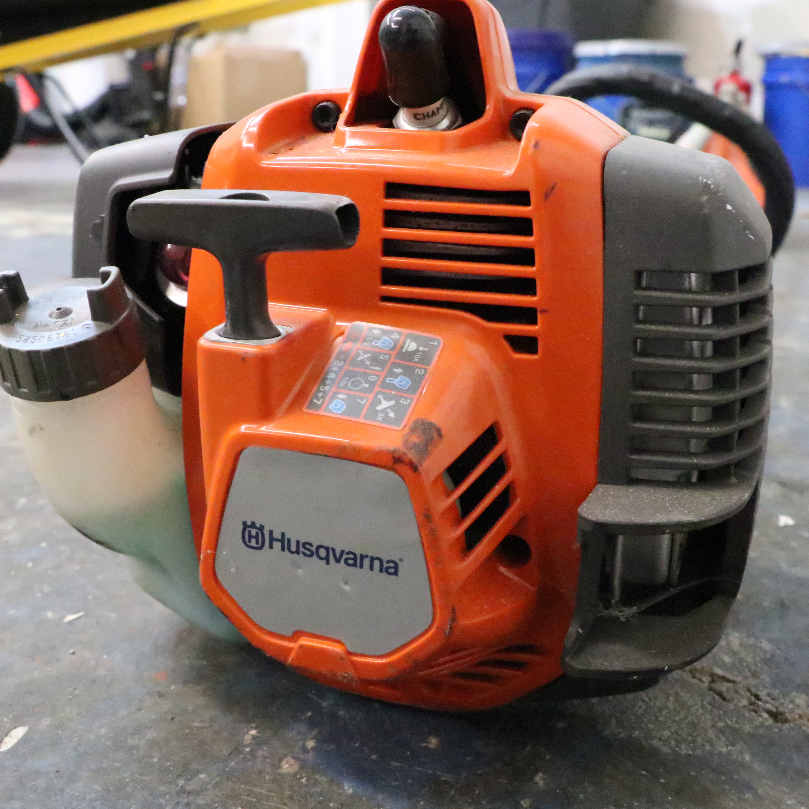 Truper Wheelbarrow With Husqvarna Gas-Powered String Trimmer