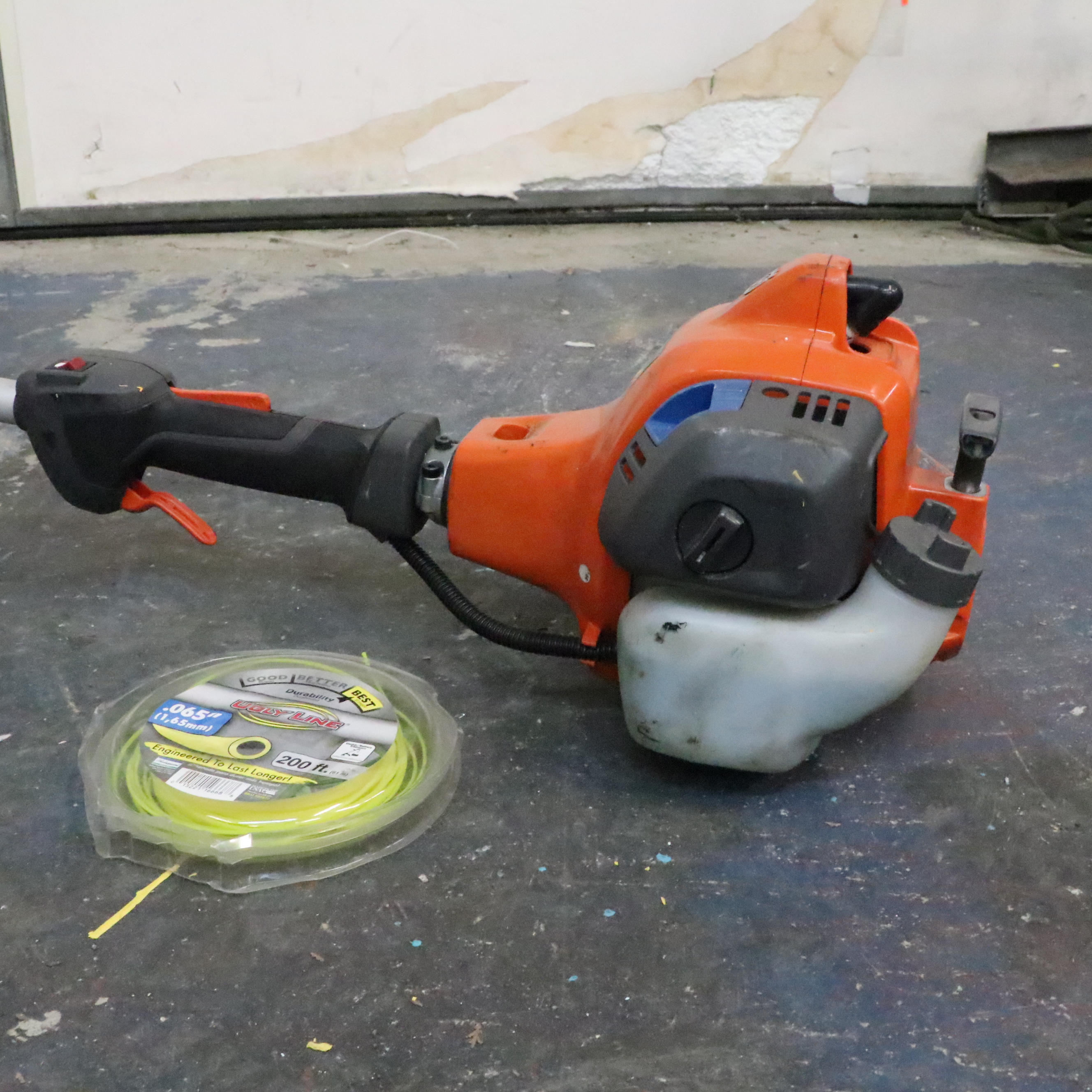 Truper Wheelbarrow With Husqvarna Gas-Powered String Trimmer