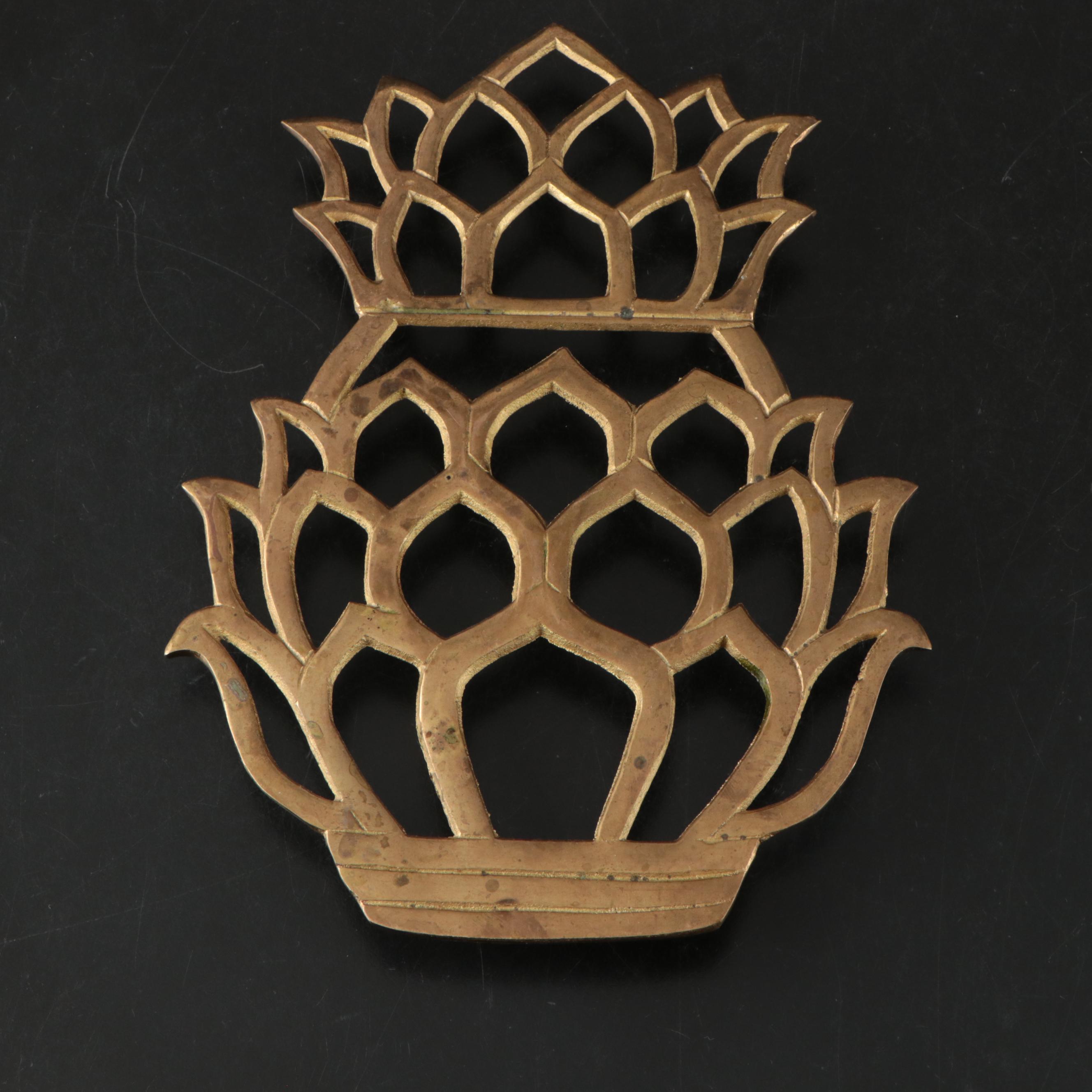 Virginia Metalcrafters "Kings Arms" with Other Brass Trivets and Candlesticks