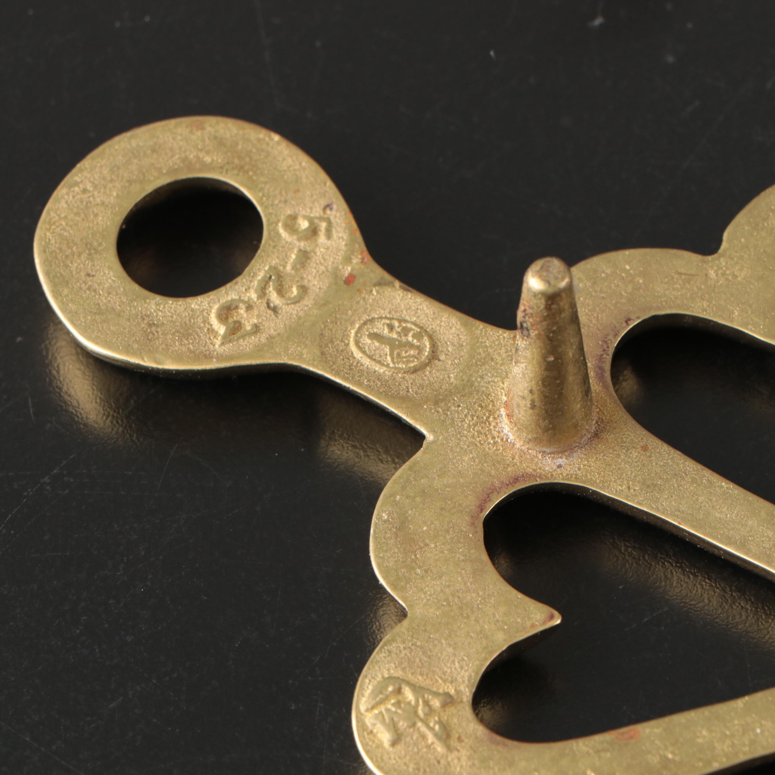 Virginia Metalcrafters "Kings Arms" with Other Brass Trivets and Candlesticks