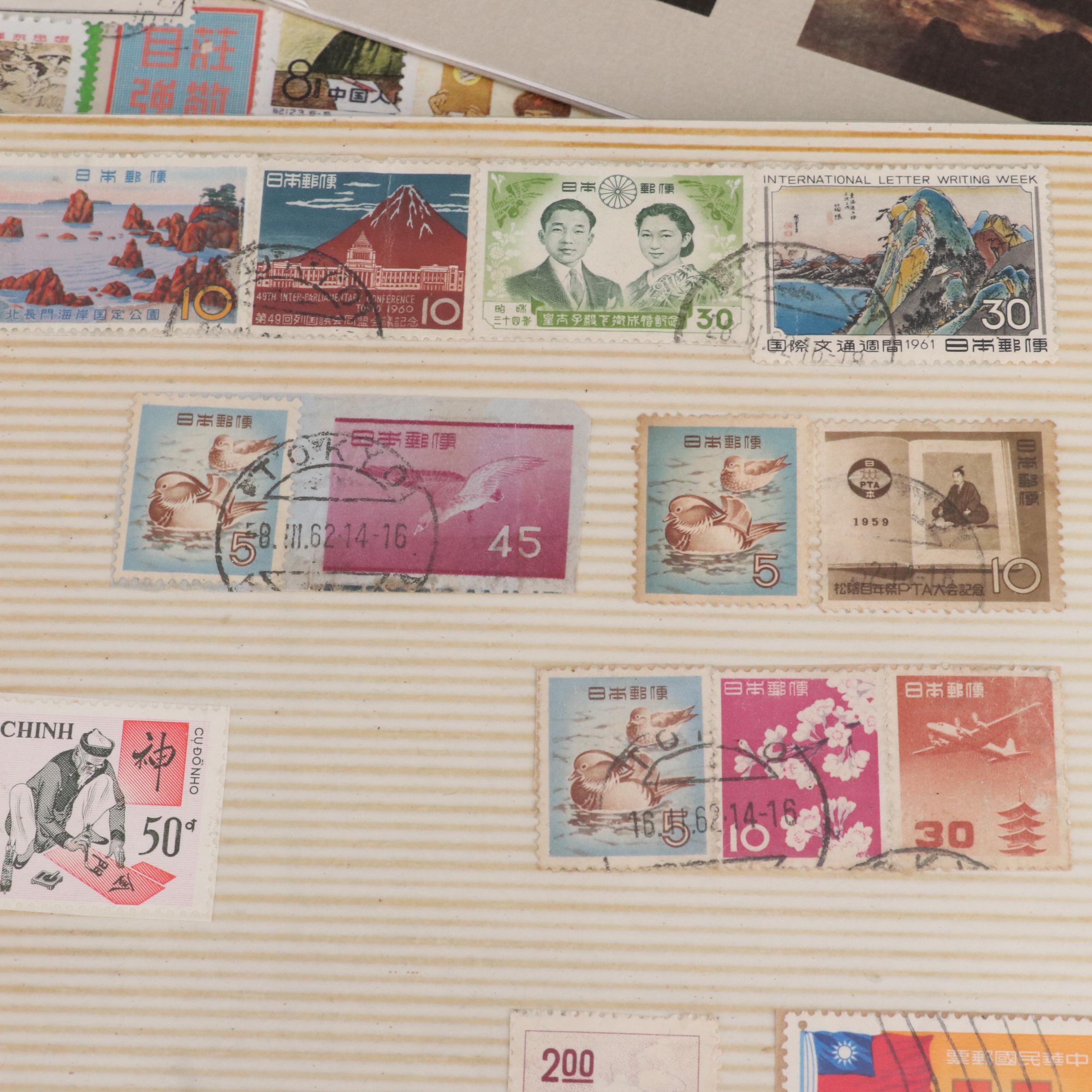 Two Chinese Postage Stamp Sets, an Album of World Stamps, and More
