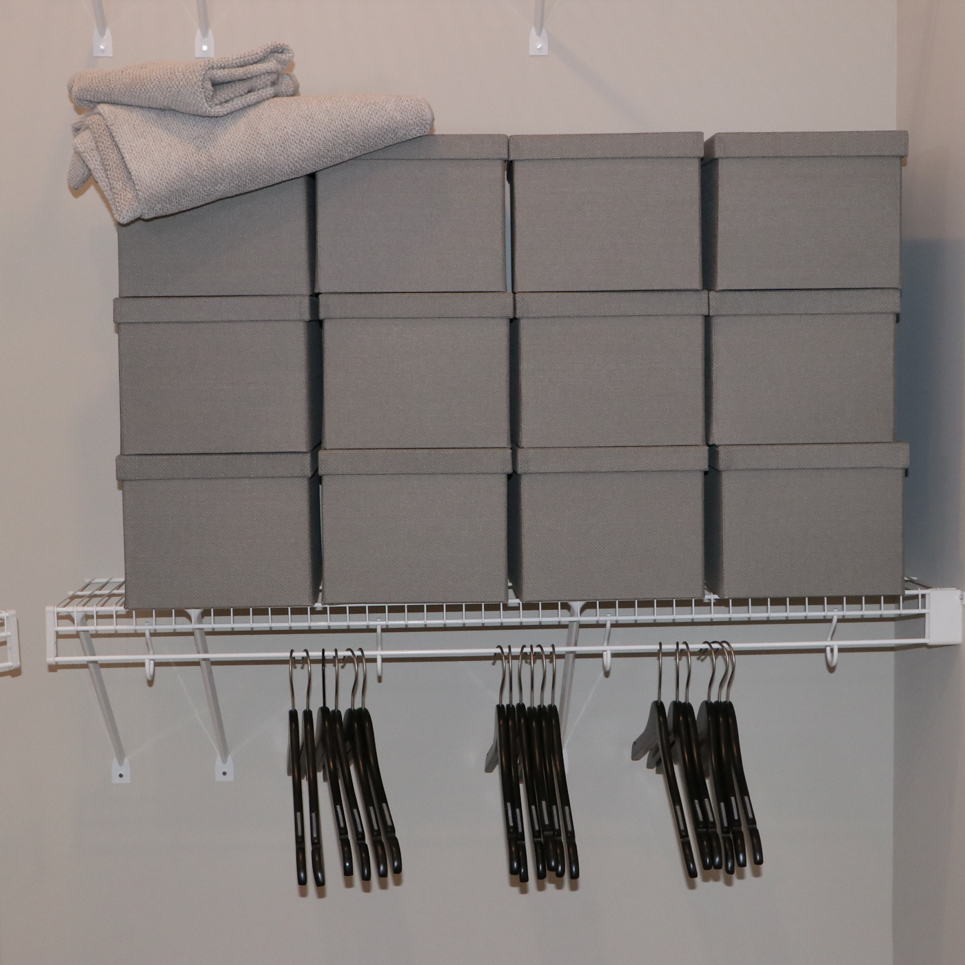 Grey Fabric Shoe Storage Cubes with Bath Linens and Clothes Hangers