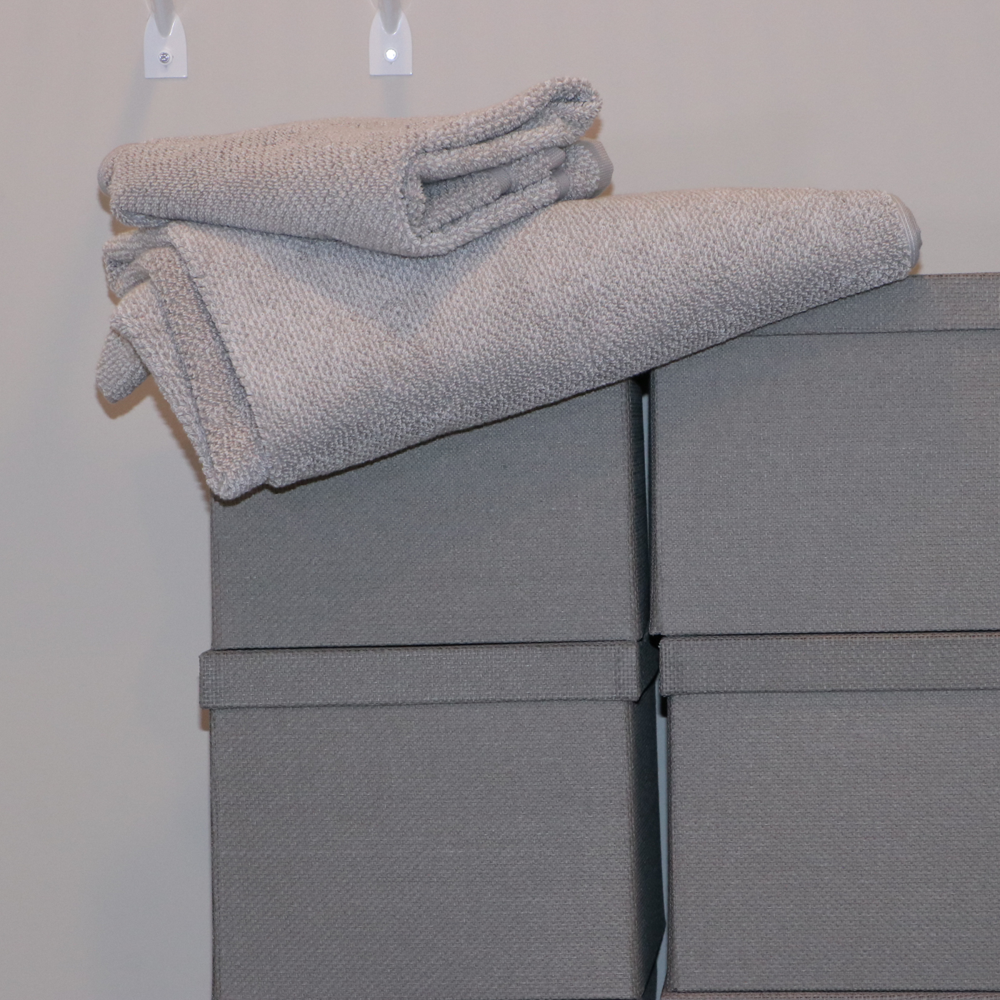 Grey Fabric Shoe Storage Cubes with Bath Linens and Clothes Hangers