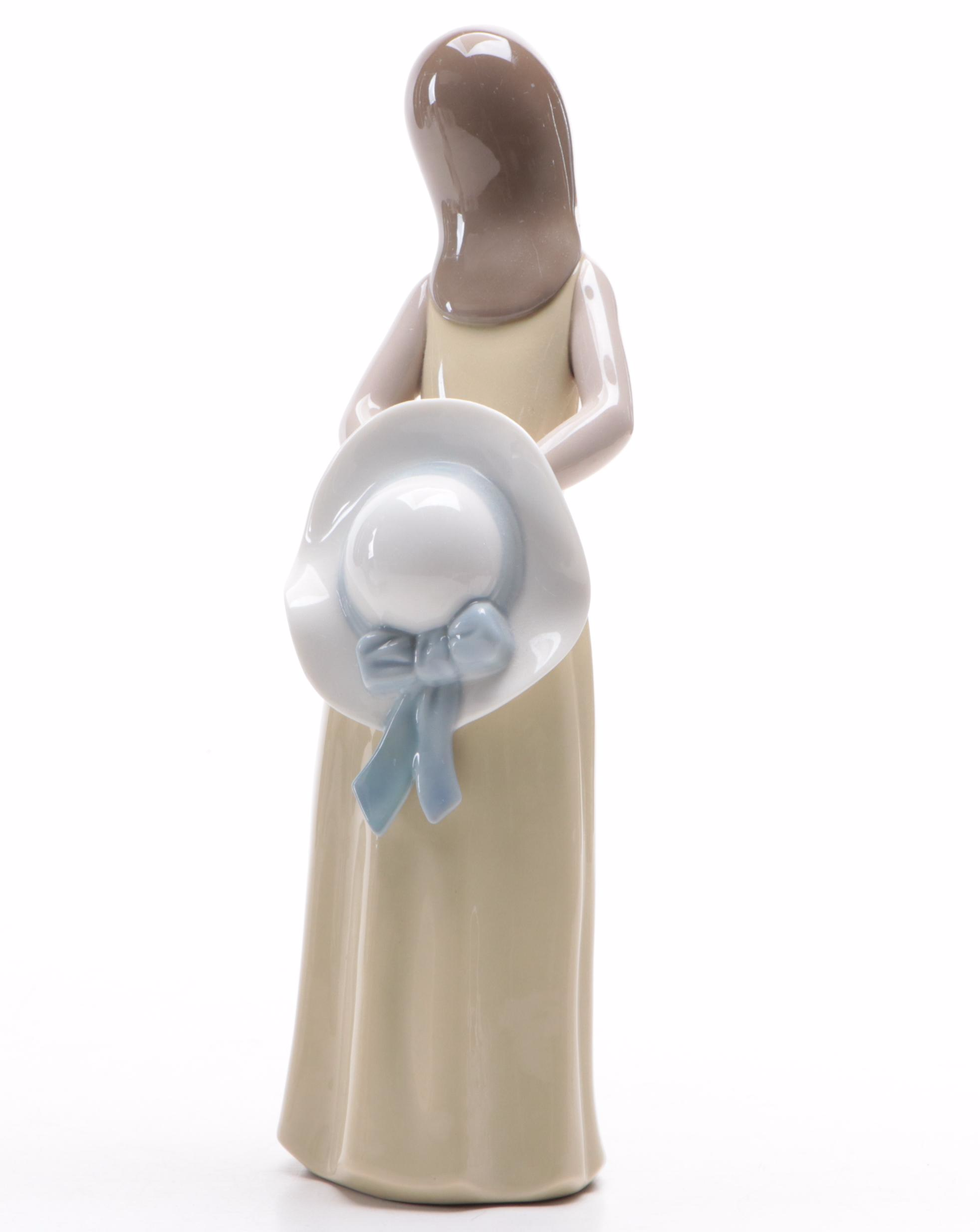 Lladró "Girl with Umbrella" and "Naughty Girl with Straw Hat" Figurines