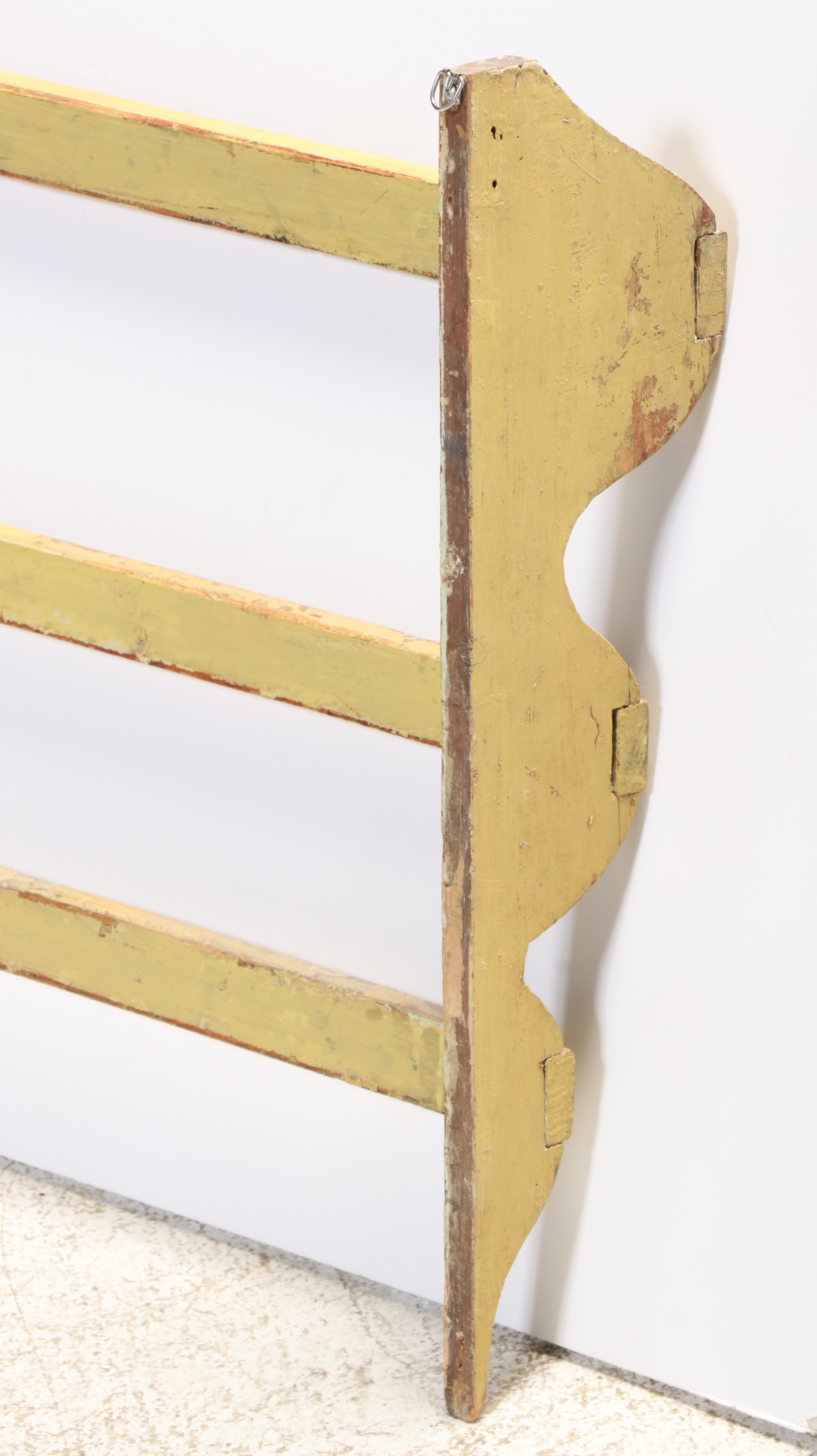 Large American Primitive Yellow-Painted Pine Three-Tier Wall-Mounted Quilt Rack