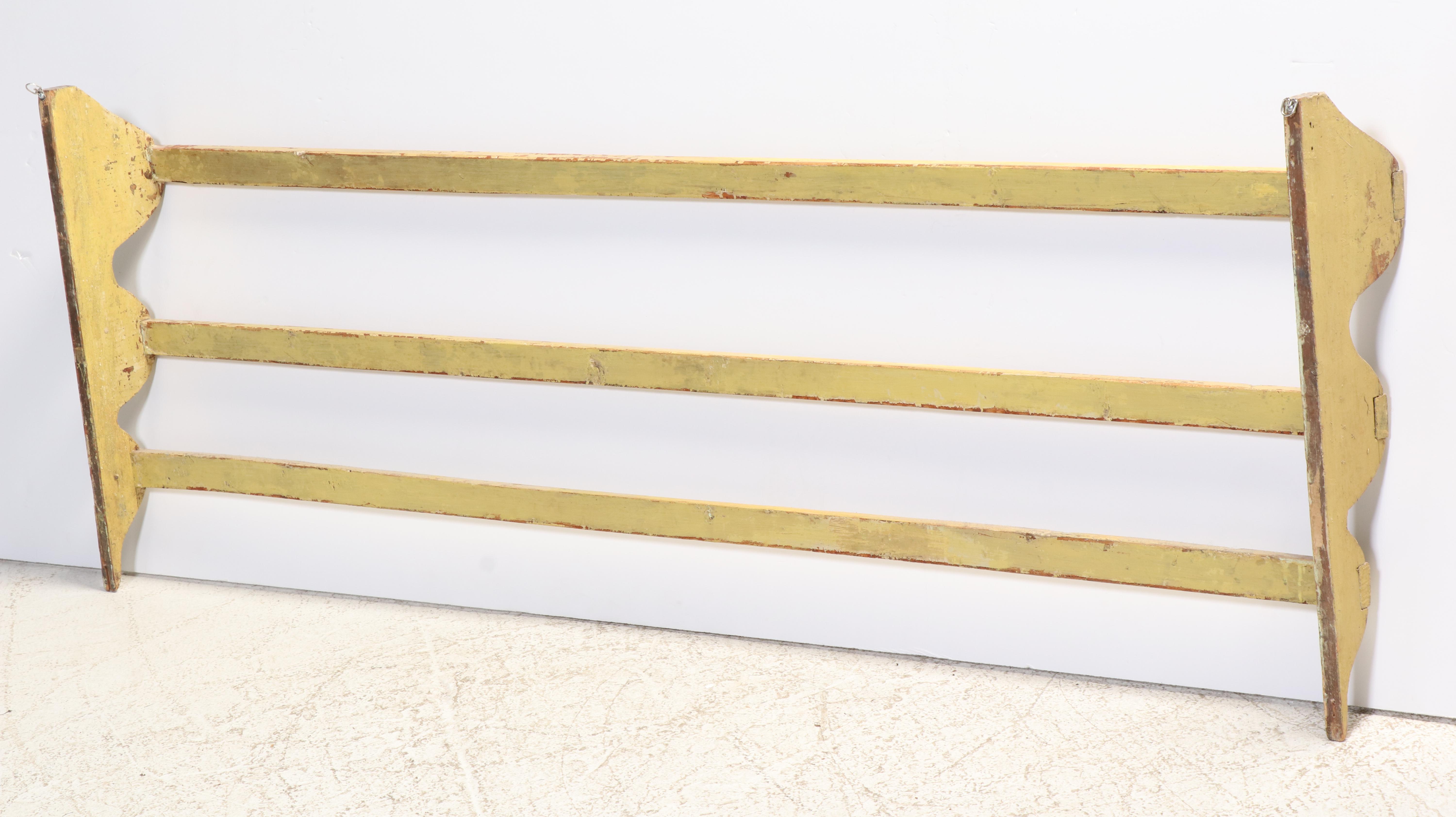 Large American Primitive Yellow-Painted Pine Three-Tier Wall-Mounted Quilt Rack