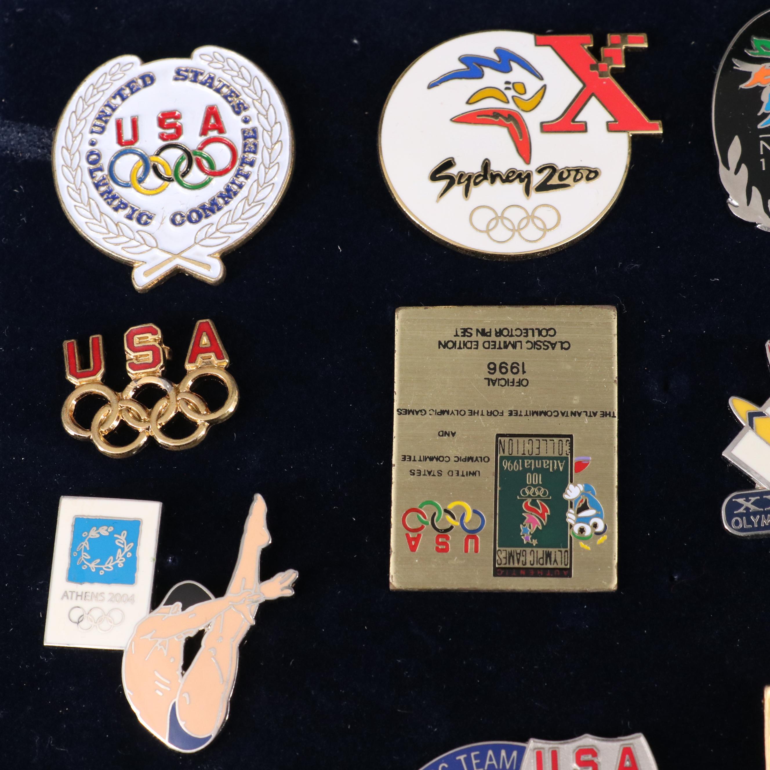 Twenty Commemorative Olympic Pins and a Commemorative Medal
