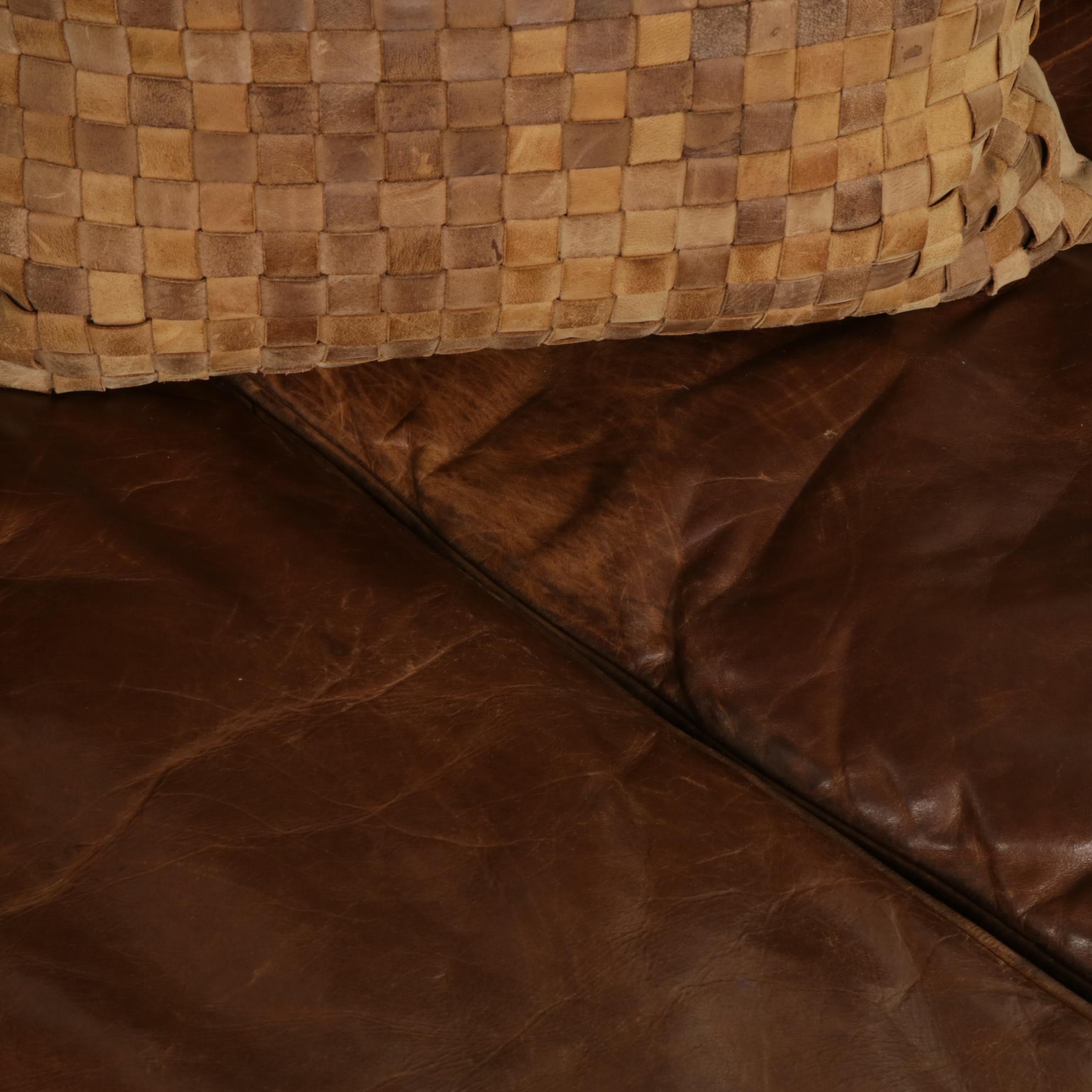 Distressed Brown Leather Sofa by Superb Creation Ltd. and Basket Weave Pillows
