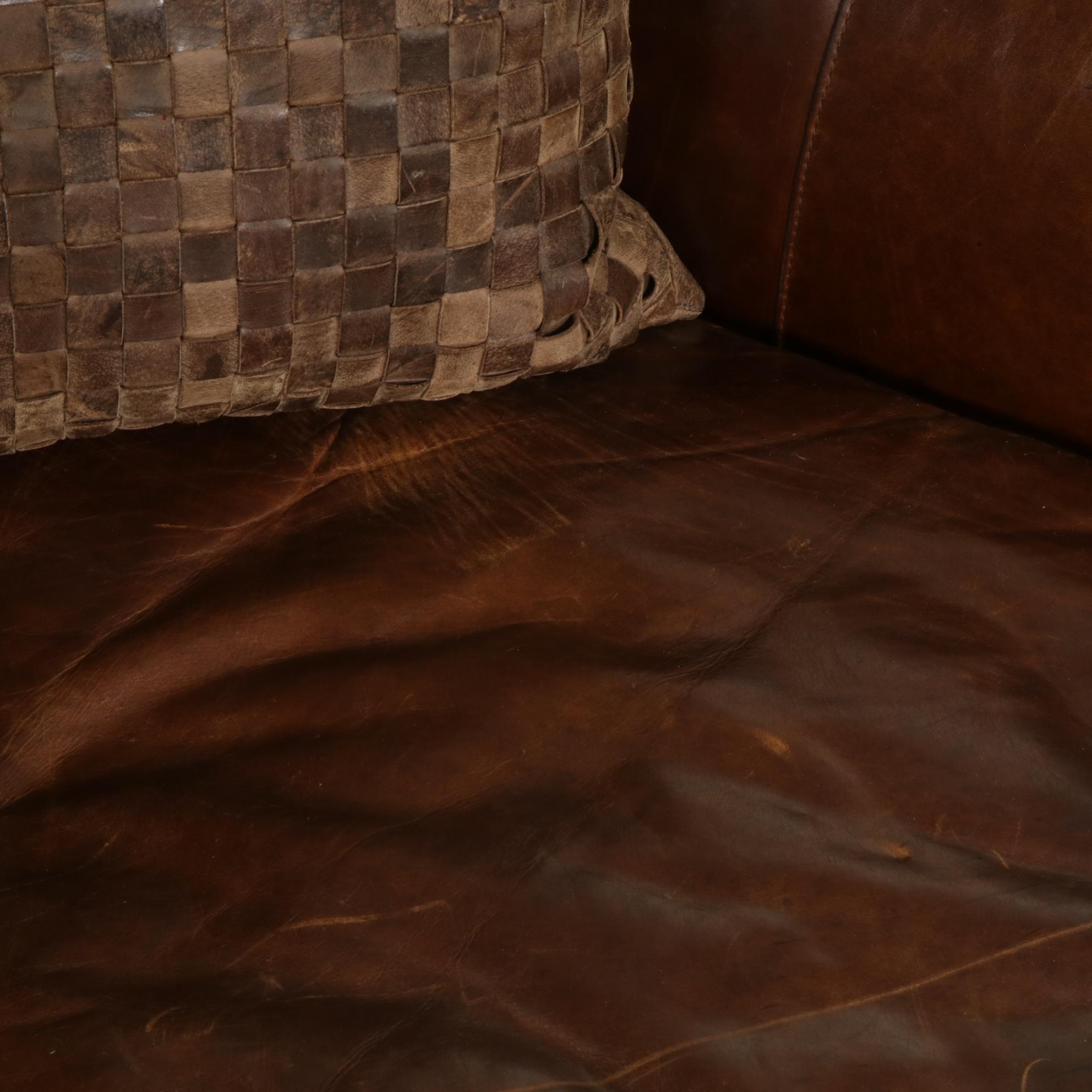 Distressed Brown Leather Sofa by Superb Creation Ltd. and Basket Weave Pillows