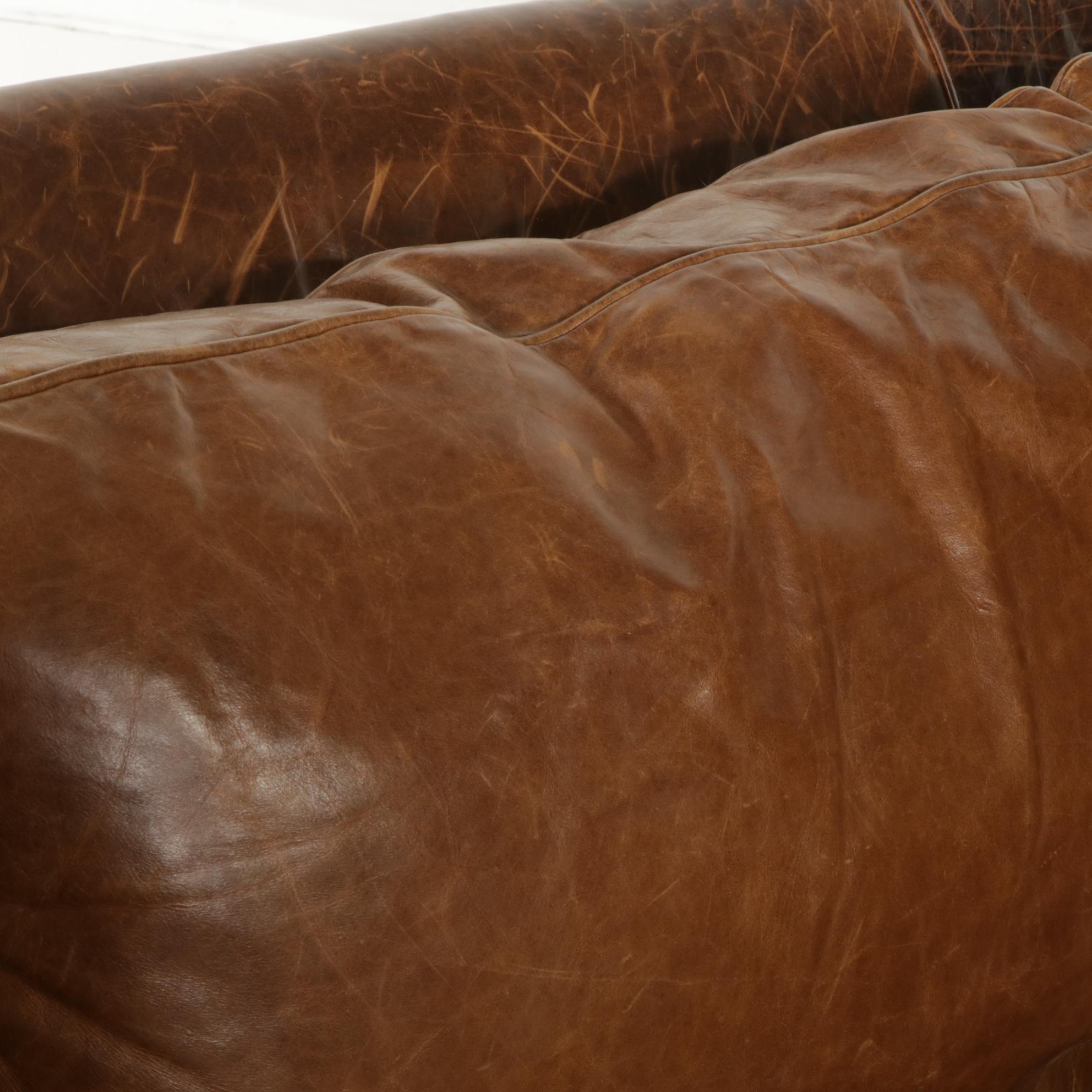Distressed Brown Leather Sofa by Superb Creation Ltd. and Basket Weave Pillows