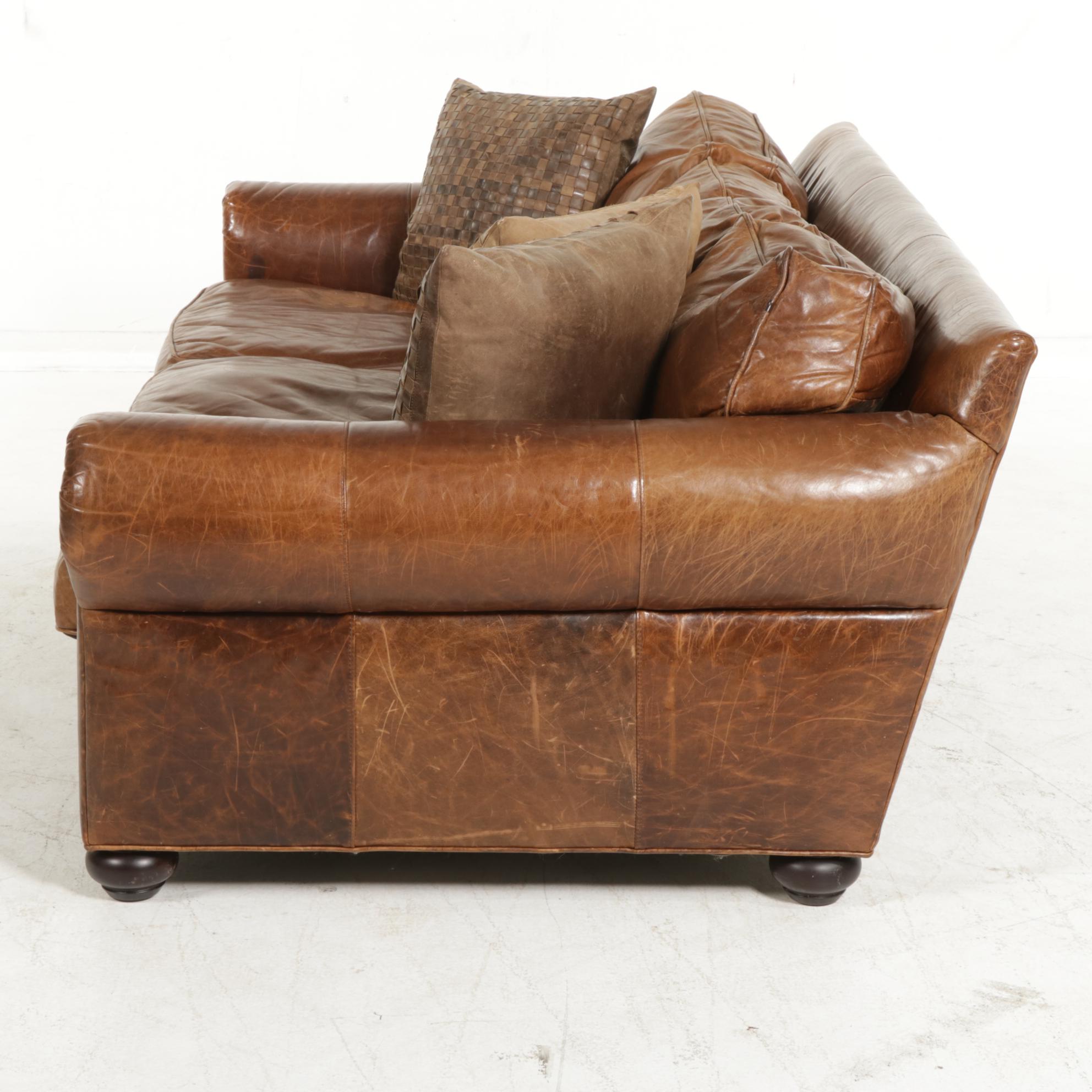 Distressed Brown Leather Sofa by Superb Creation Ltd. and Basket Weave Pillows