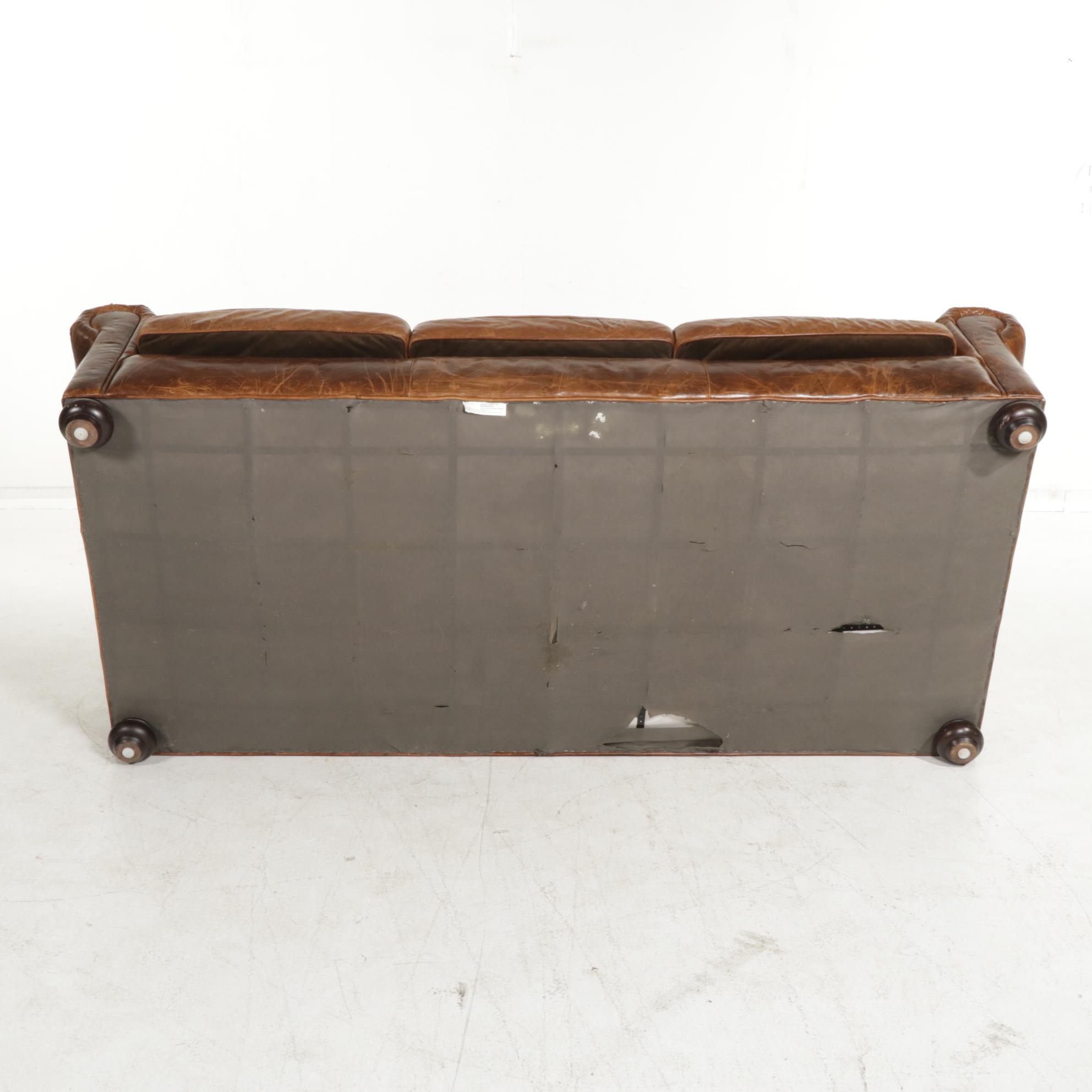 Distressed Brown Leather Sofa by Superb Creation Ltd. and Basket Weave Pillows