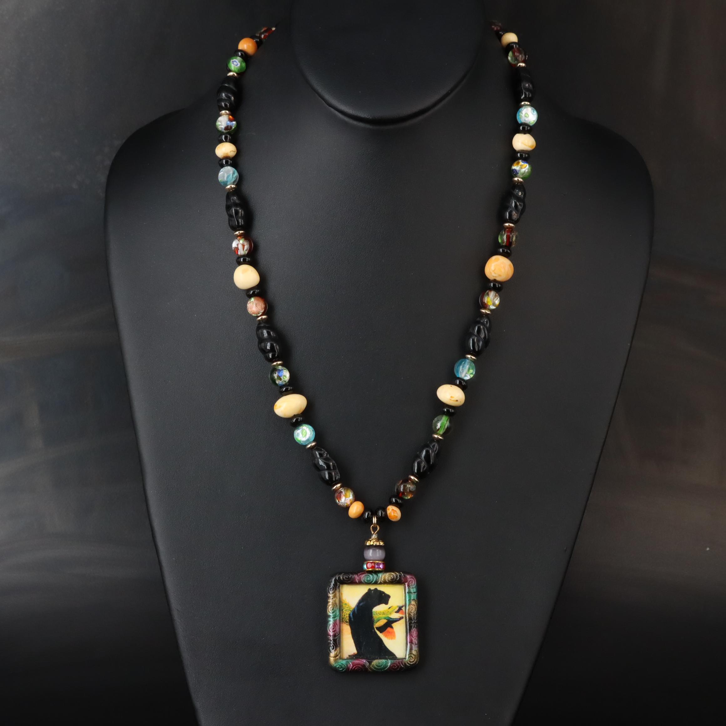 The Indigo Dragon and Art Glass Featured in Necklace and Pendant Collection