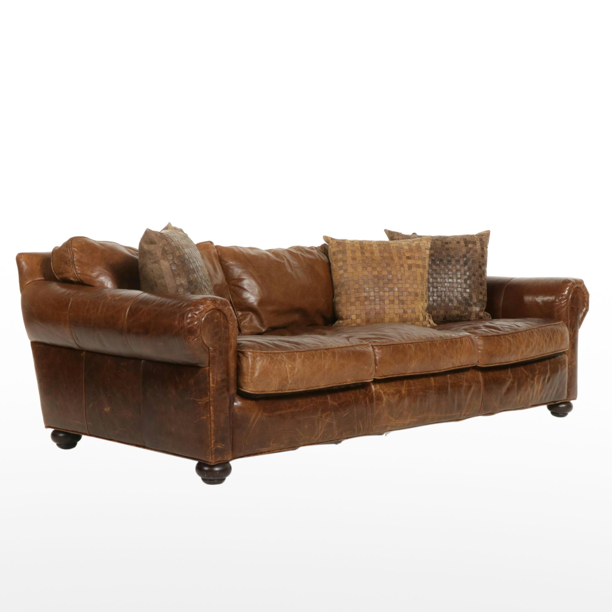 Distressed Brown Leather Sofa by Superb Creation Ltd. and Basket Weave Pillows