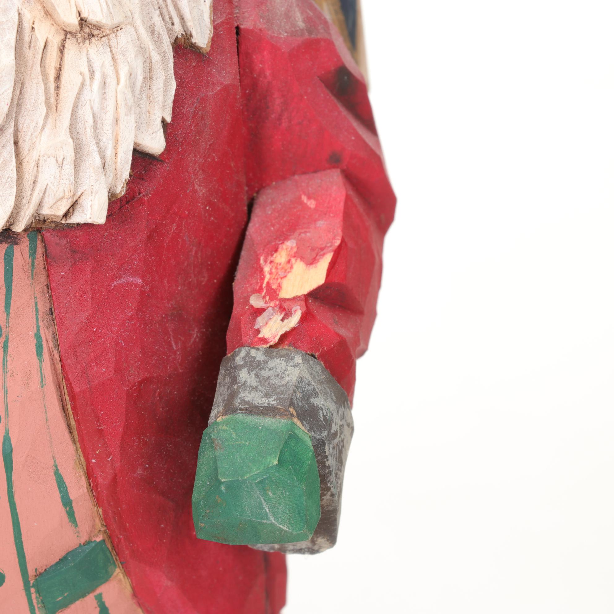 Carved Wood and Hand-Painted Folk Art Santa Figurines Including Rawson