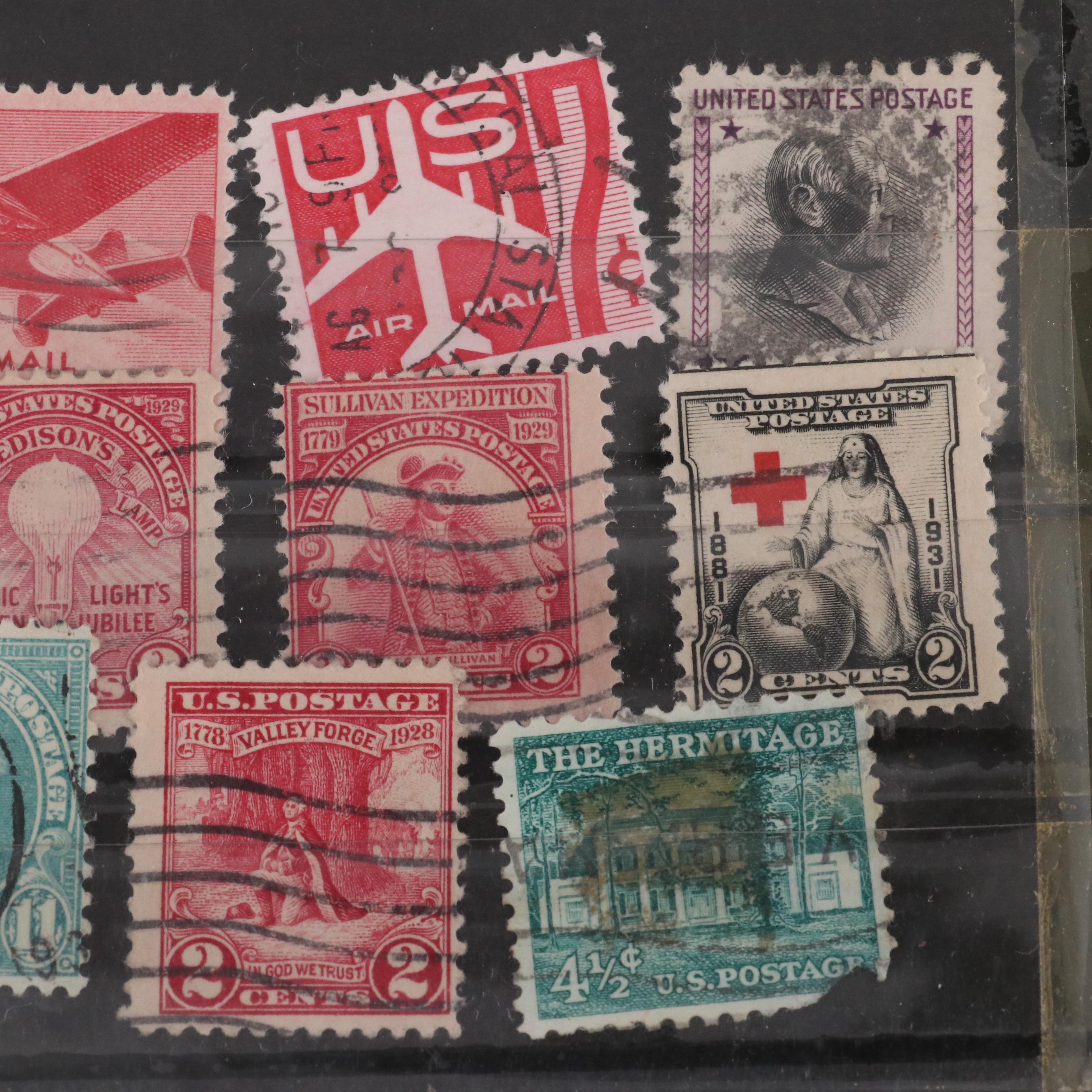 Assortment of World and U.S. Postage Stamps, Price Guide, and Binder