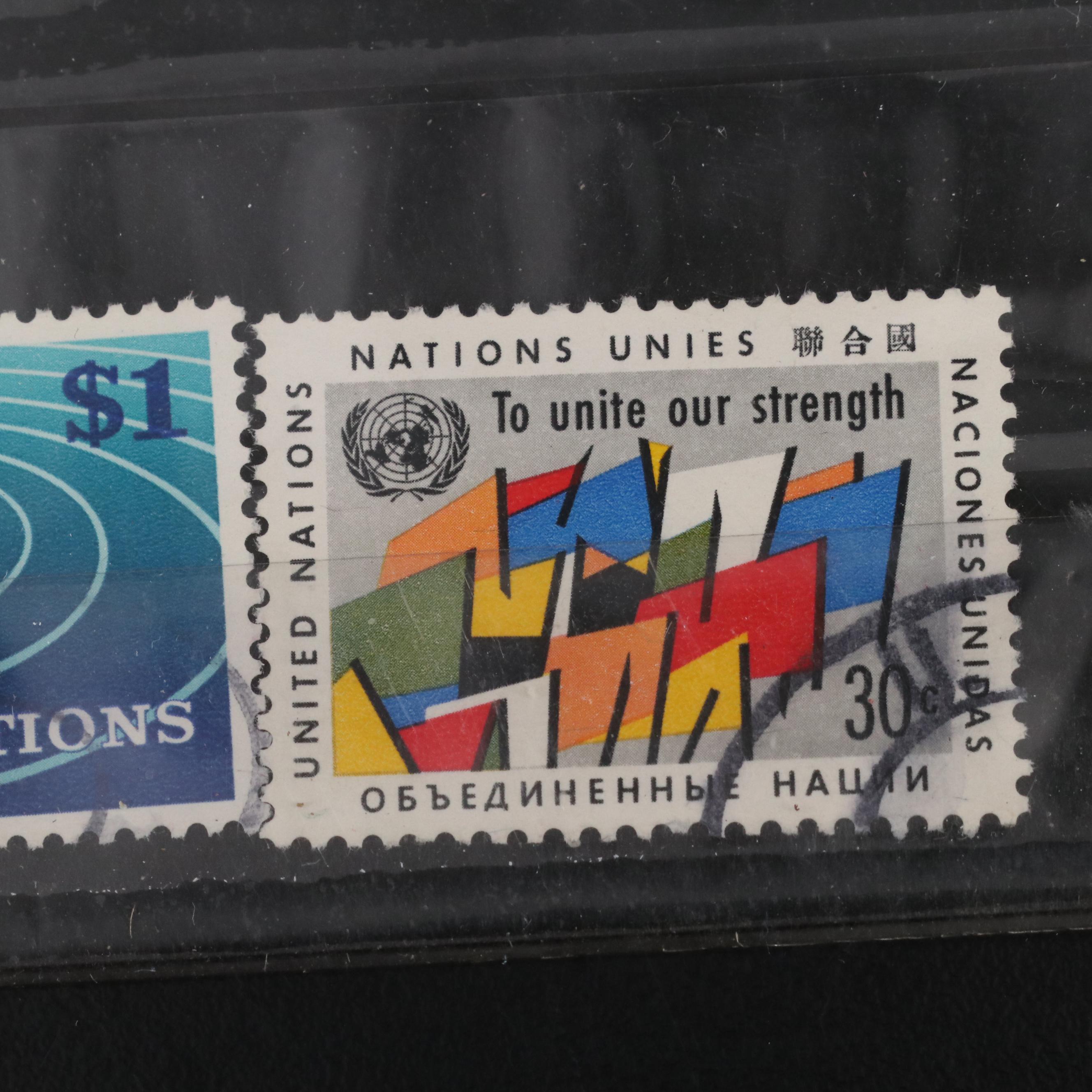 Assortment of World and U.S. Postage Stamps, Price Guide, and Binder