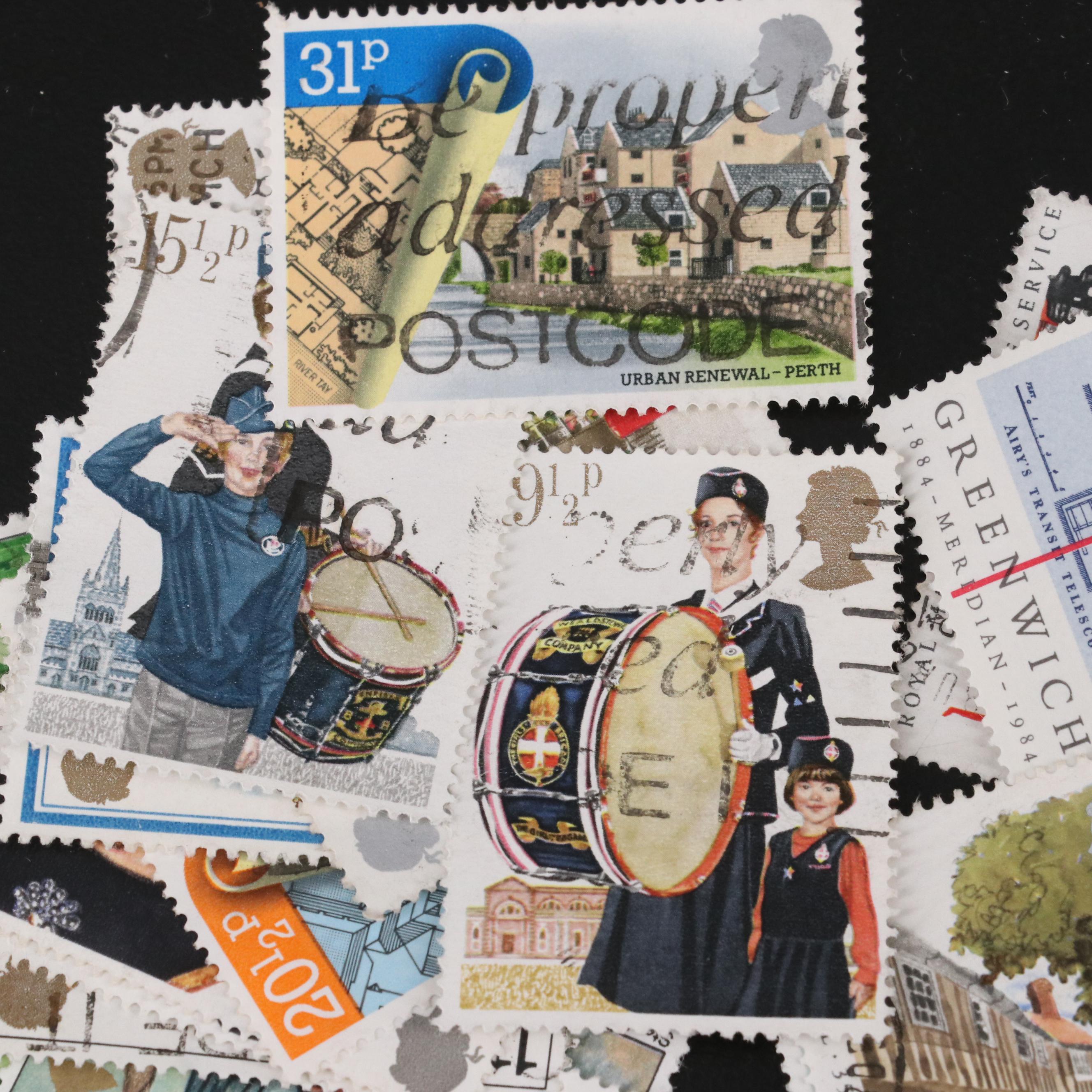 Assortment of World and U.S. Postage Stamps, Price Guide, and Binder