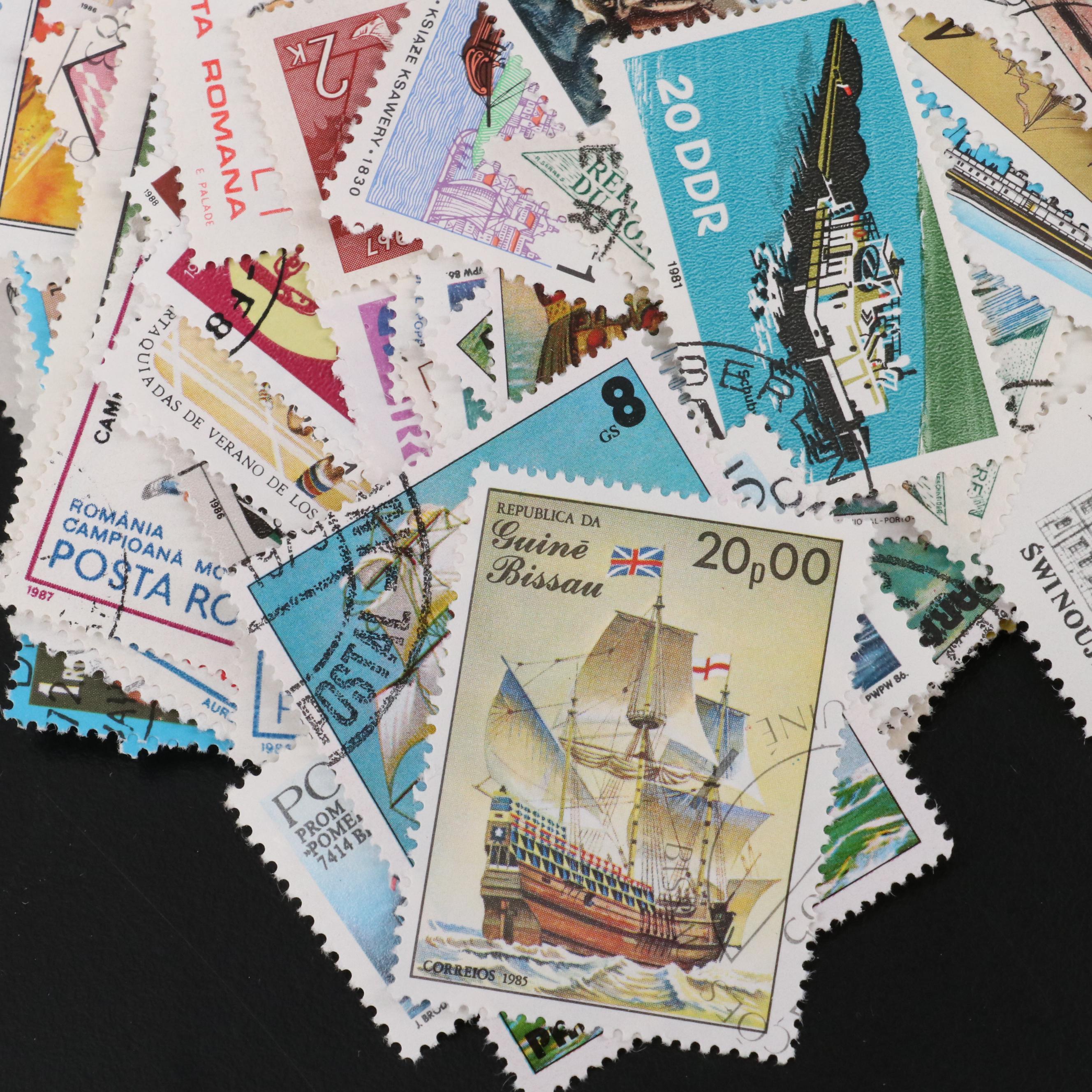 Assortment of World and U.S. Postage Stamps, Price Guide, and Binder