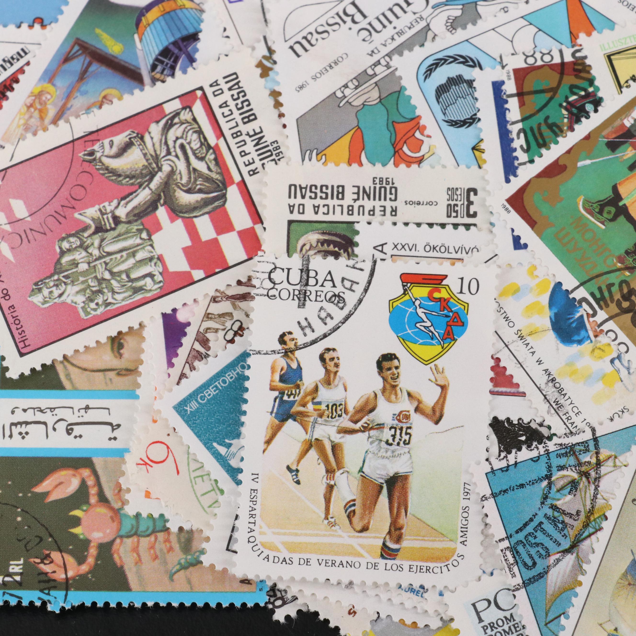 Assortment of World and U.S. Postage Stamps, Price Guide, and Binder