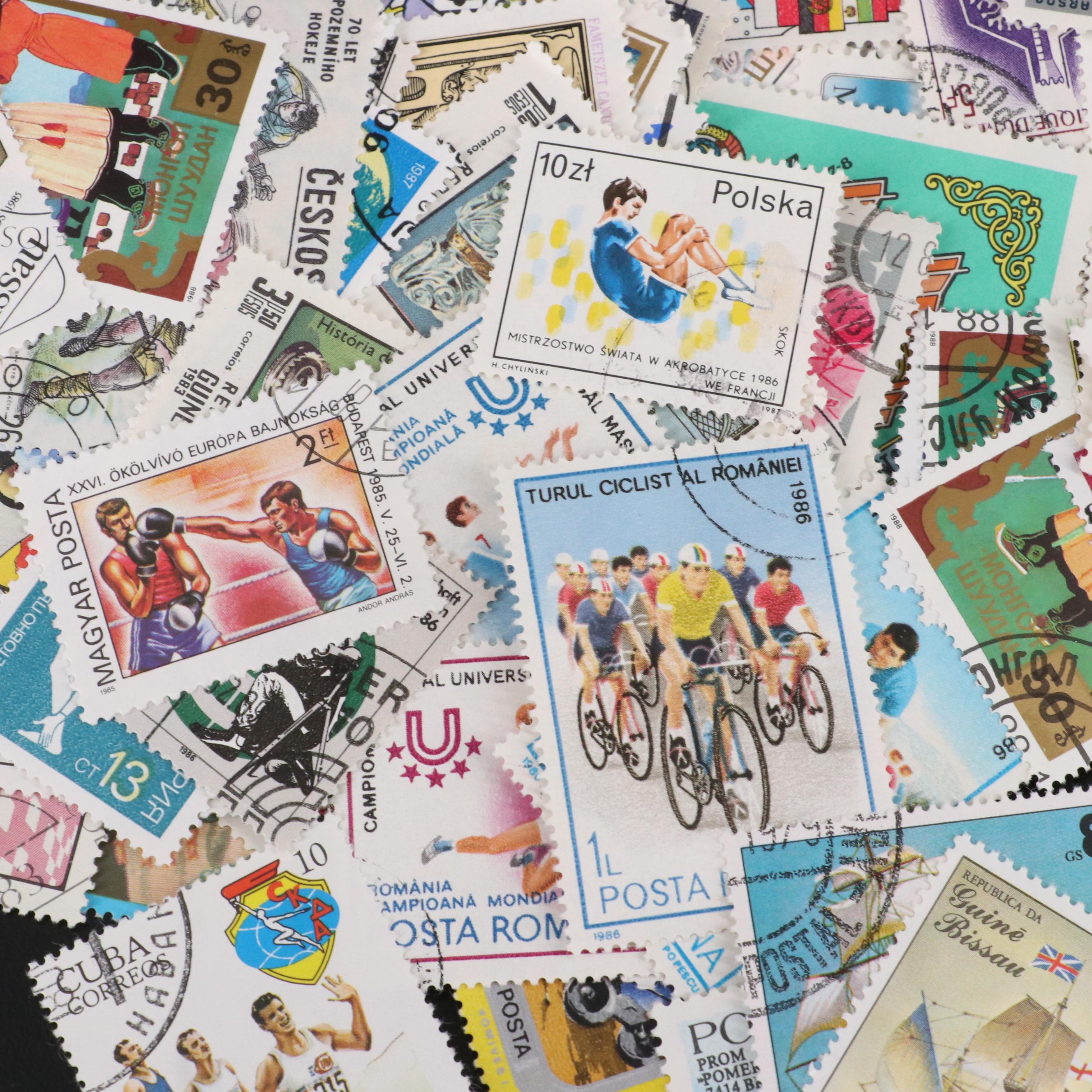 Assortment of World and U.S. Postage Stamps, Price Guide, and Binder