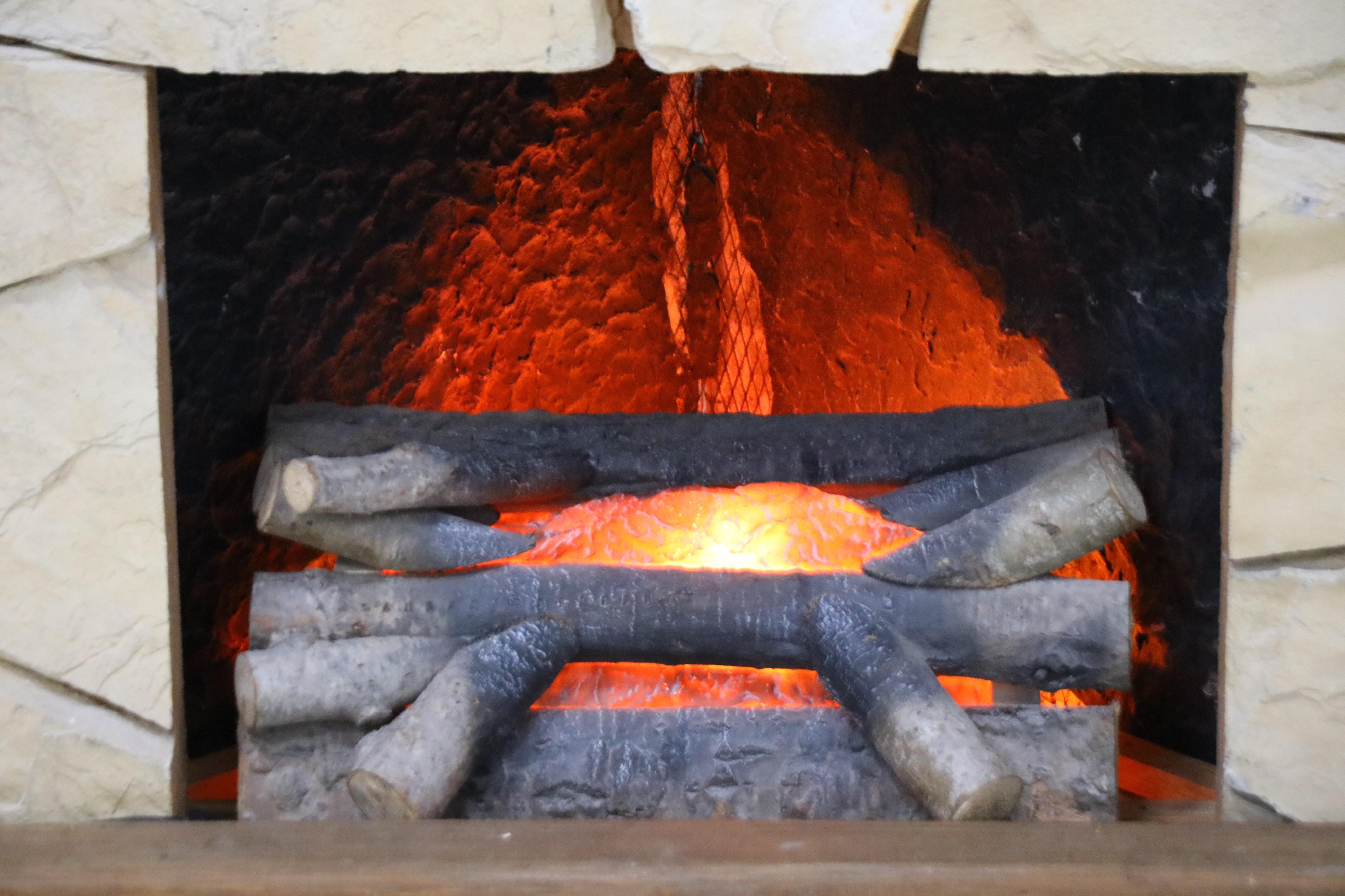 Stone Corner Fireplace with Electric Insert