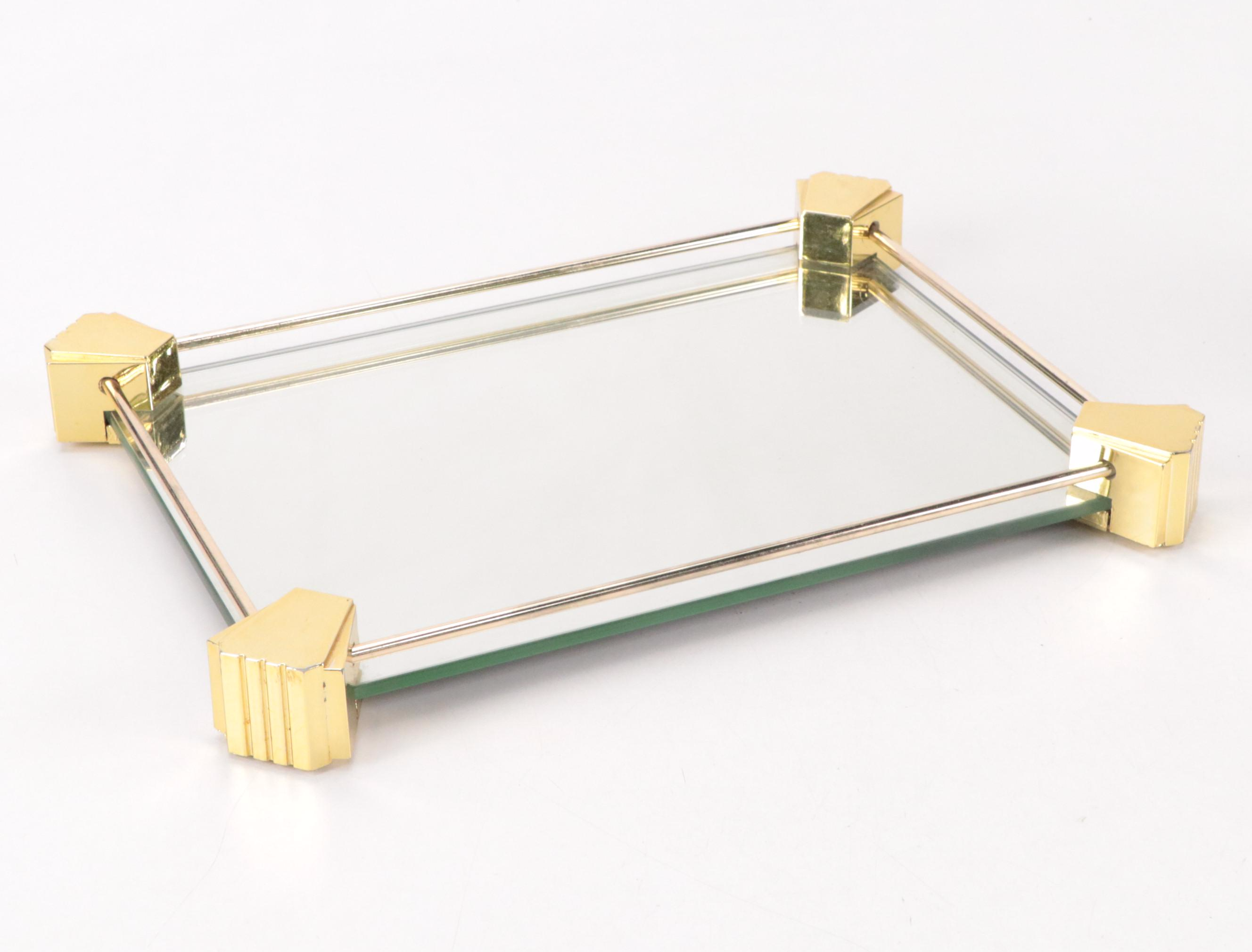 Mirrored Vanity Tray with Embossed Lidded Jars and Brass Candlesticks, 20th C.