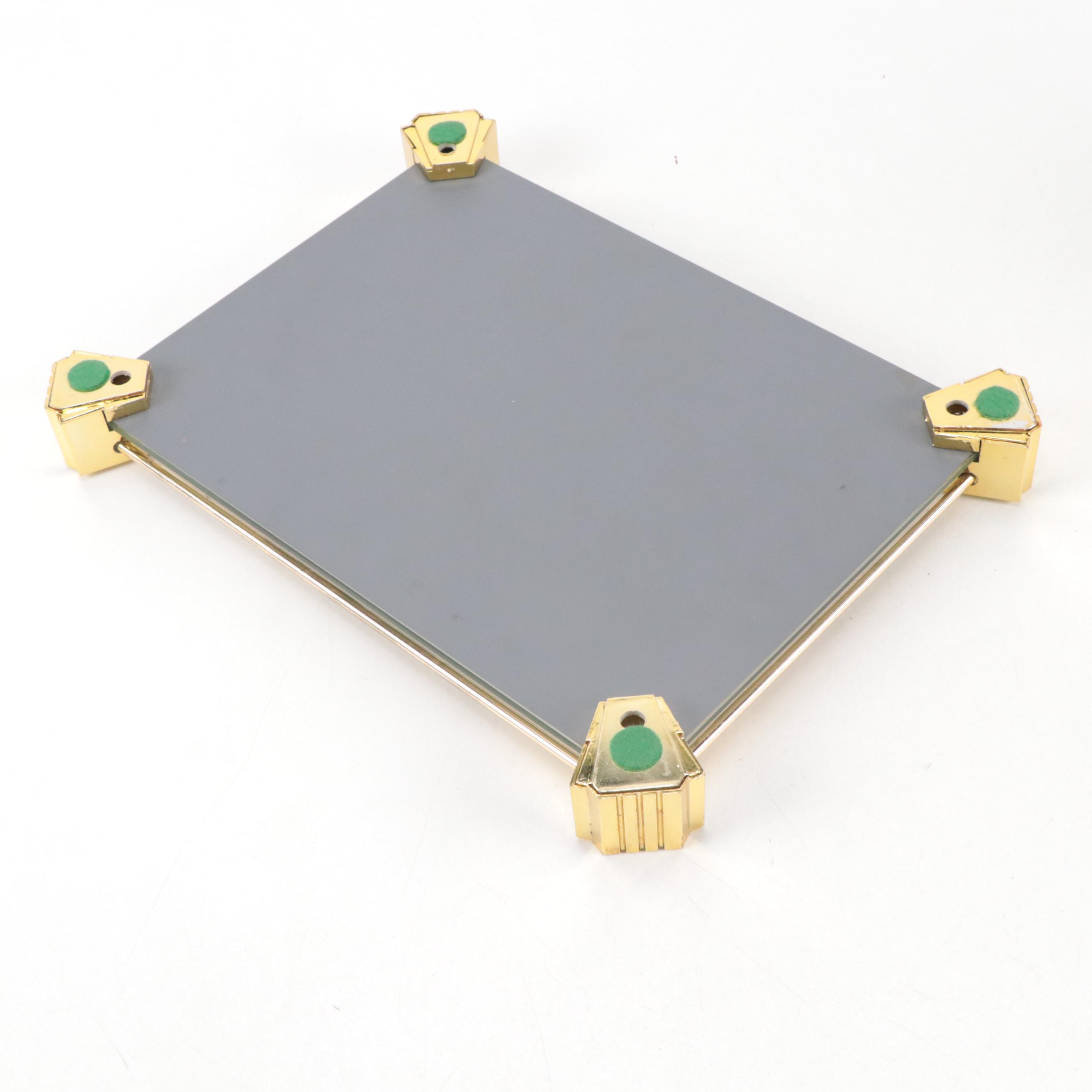 Mirrored Vanity Tray with Embossed Lidded Jars and Brass Candlesticks, 20th C.