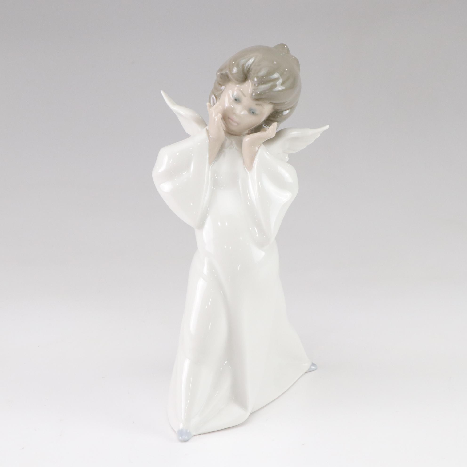 Lladró "Puzzled Cherub" and Royal Doulton "Bedtime" Figurines