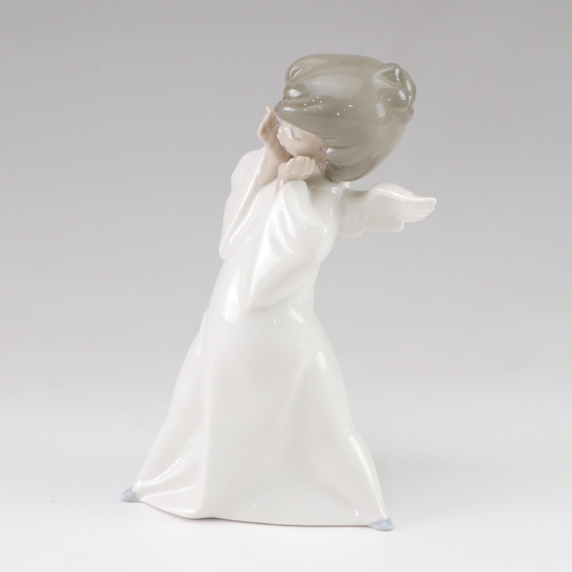 Lladró "Puzzled Cherub" and Royal Doulton "Bedtime" Figurines