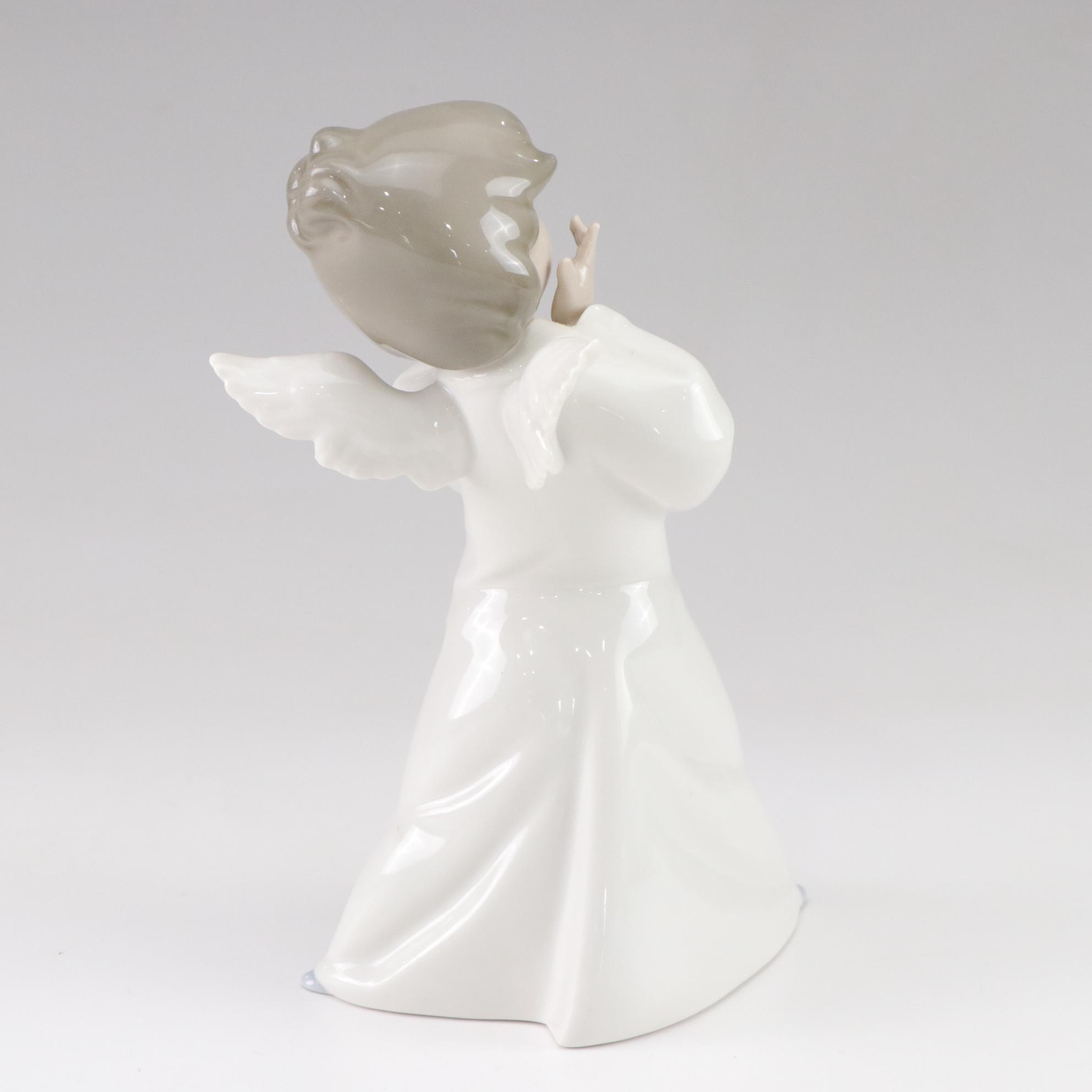 Lladró "Puzzled Cherub" and Royal Doulton "Bedtime" Figurines