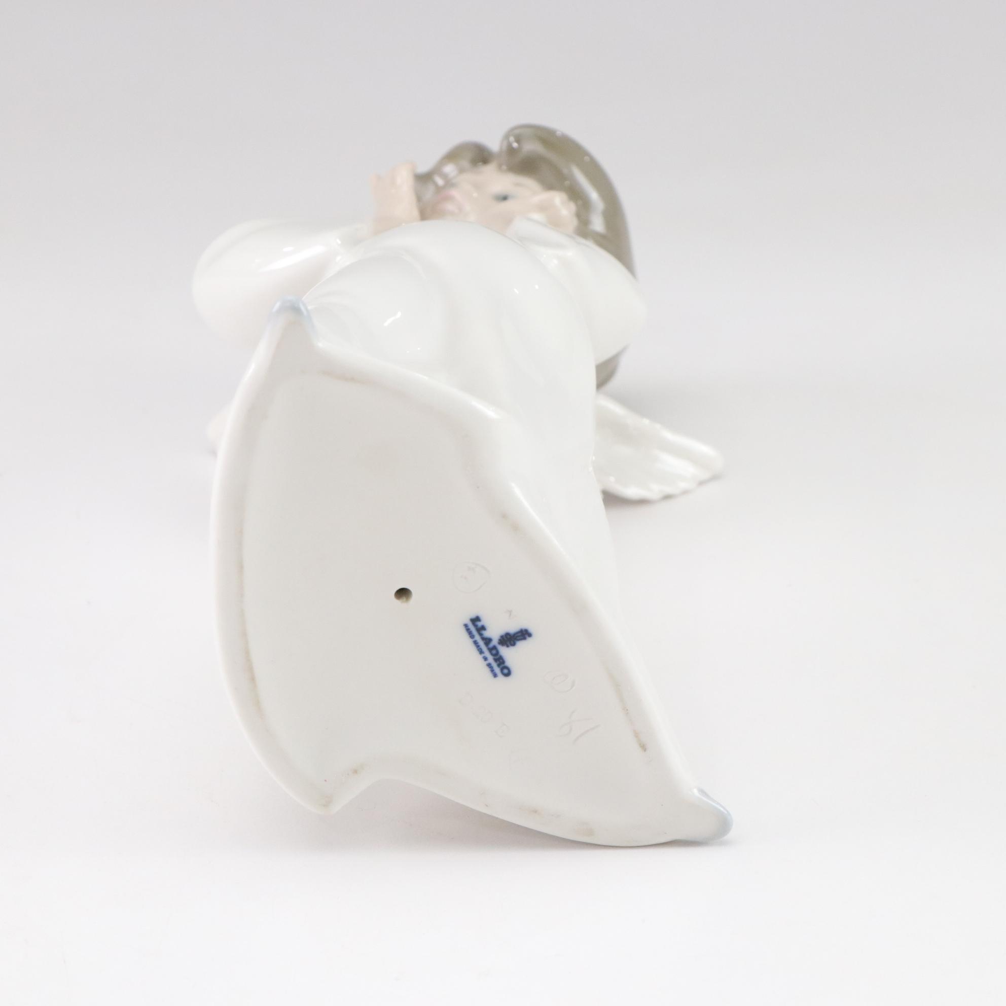 Lladró "Puzzled Cherub" and Royal Doulton "Bedtime" Figurines