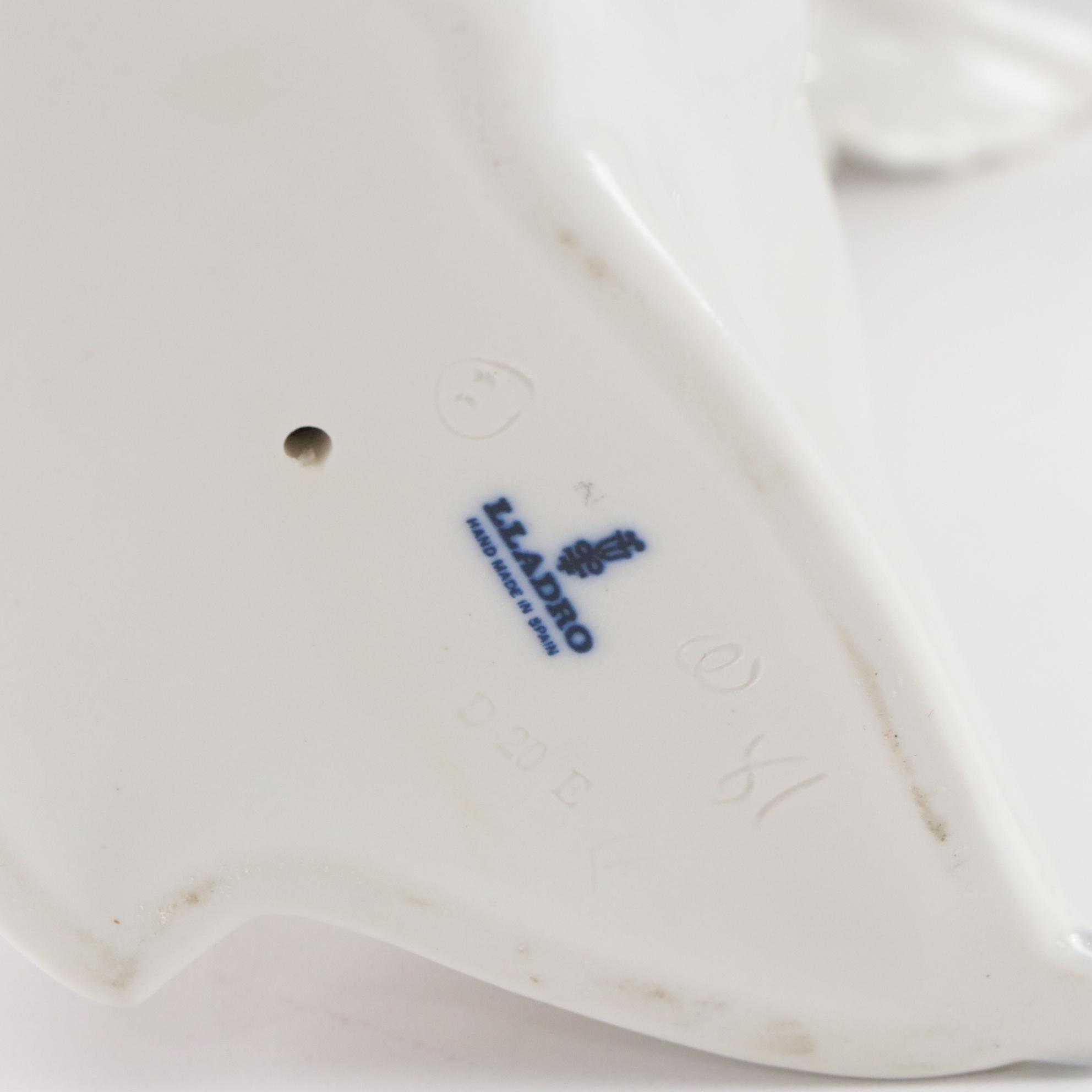 Lladró "Puzzled Cherub" and Royal Doulton "Bedtime" Figurines