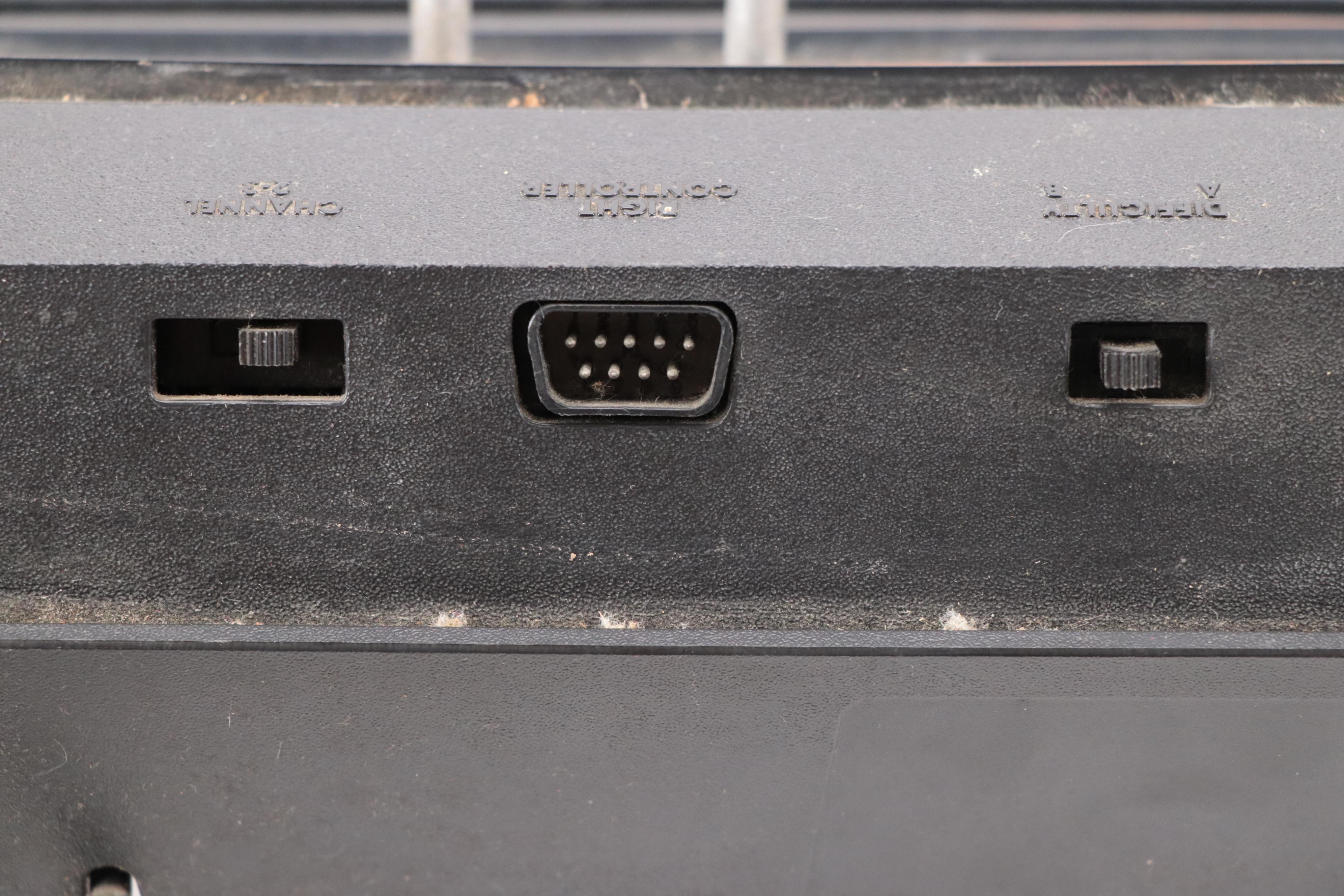 Atari 2600 Console with "Donkey Kong", "Frogger", "Pac-Man", and More