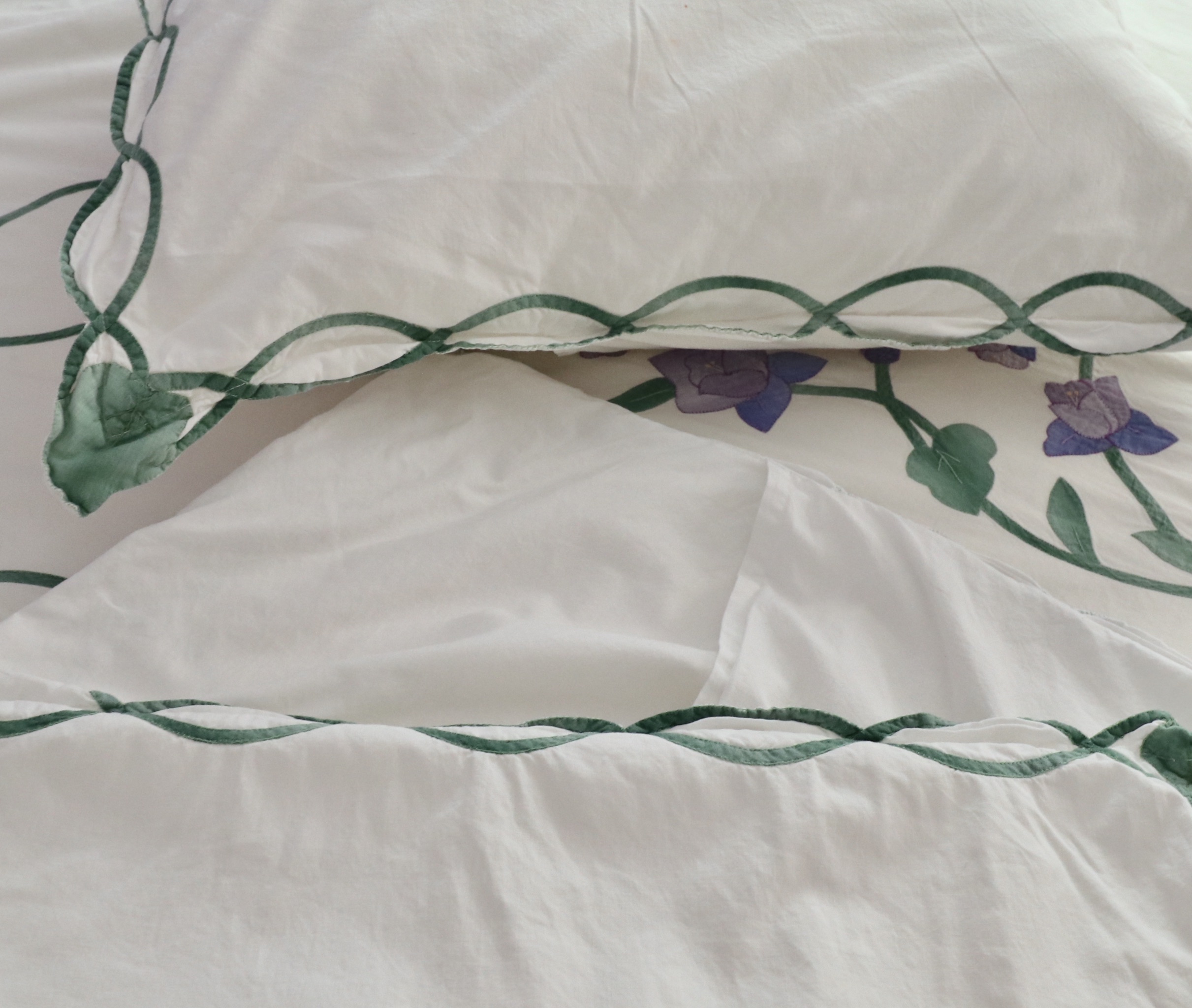 Wrought Iron Queen Bed Frame with Side Table and Floral Appliqué Cotton Bedding