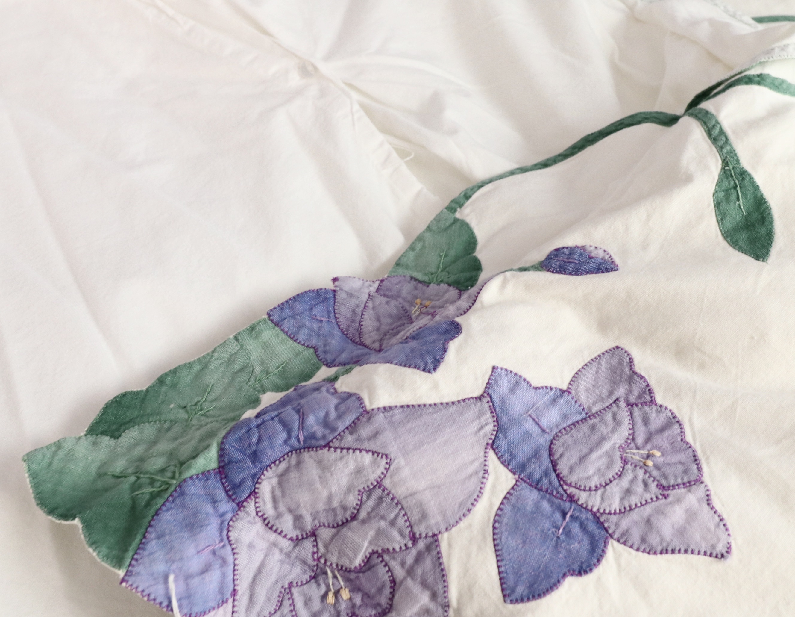 Wrought Iron Queen Bed Frame with Side Table and Floral Appliqué Cotton Bedding