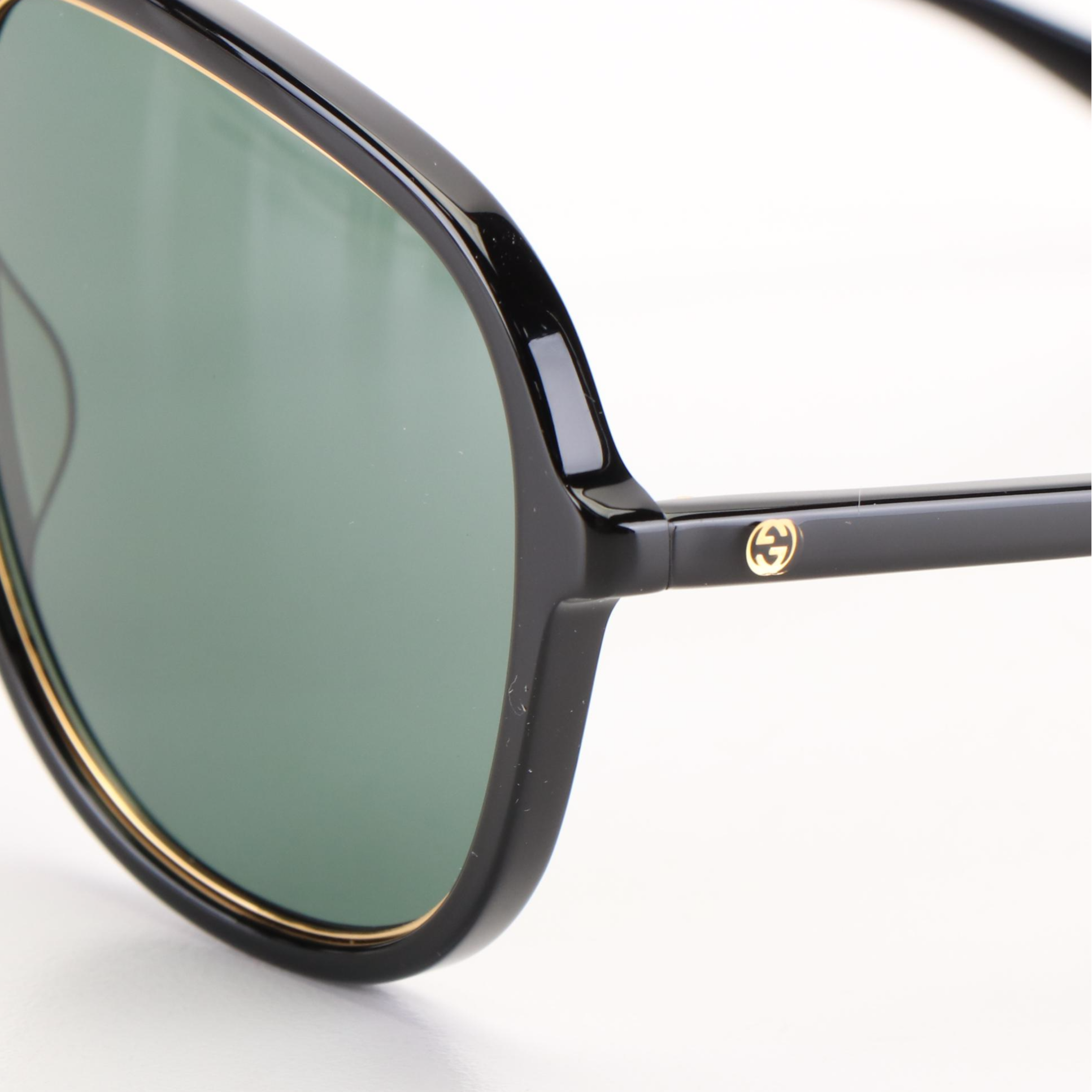 Gucci GG 1077S Aviator Sunglasses with Black Frames and Green Lenses