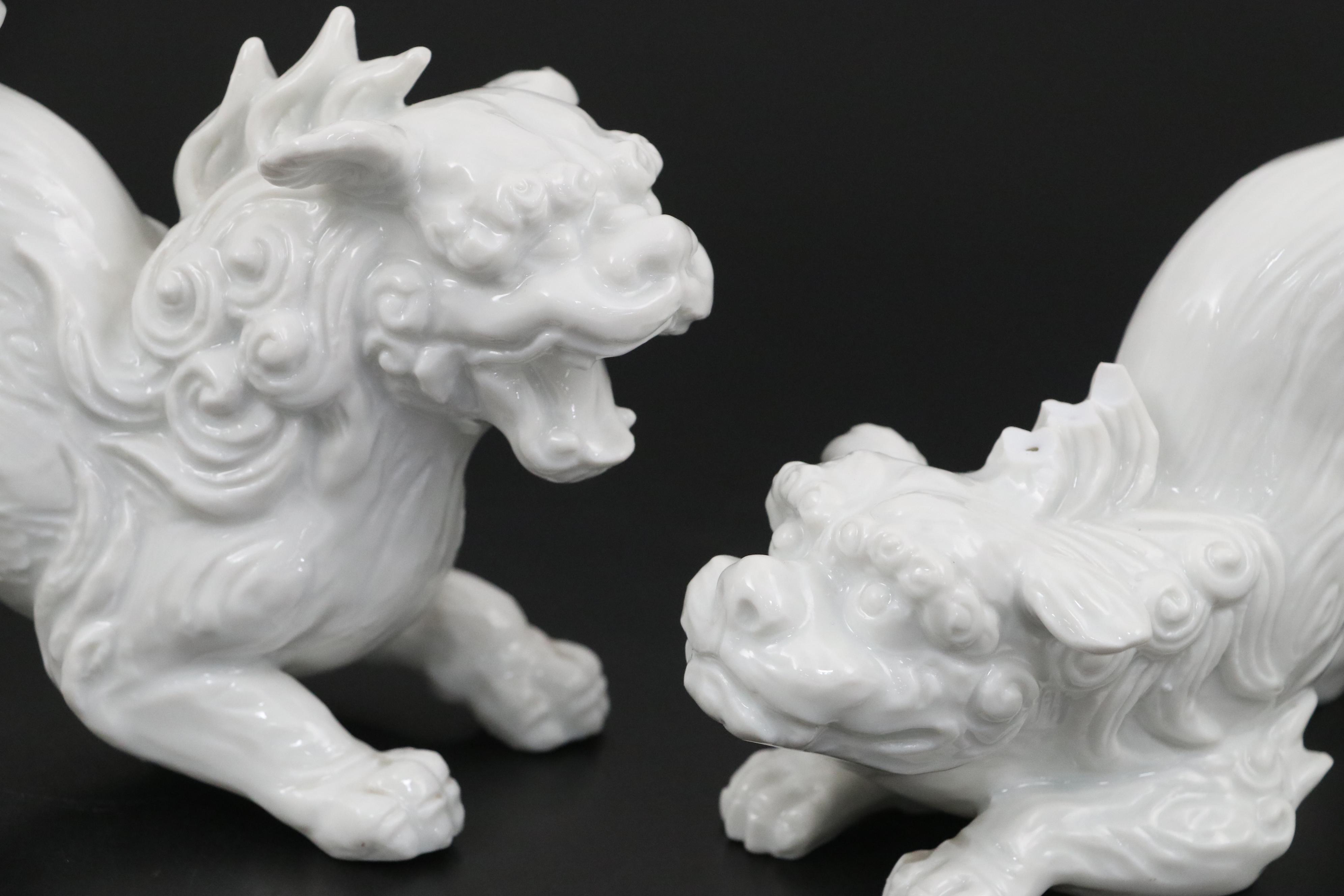 Chinese Blanc de Chine and Resin Guardian Lion Figurine Pairs