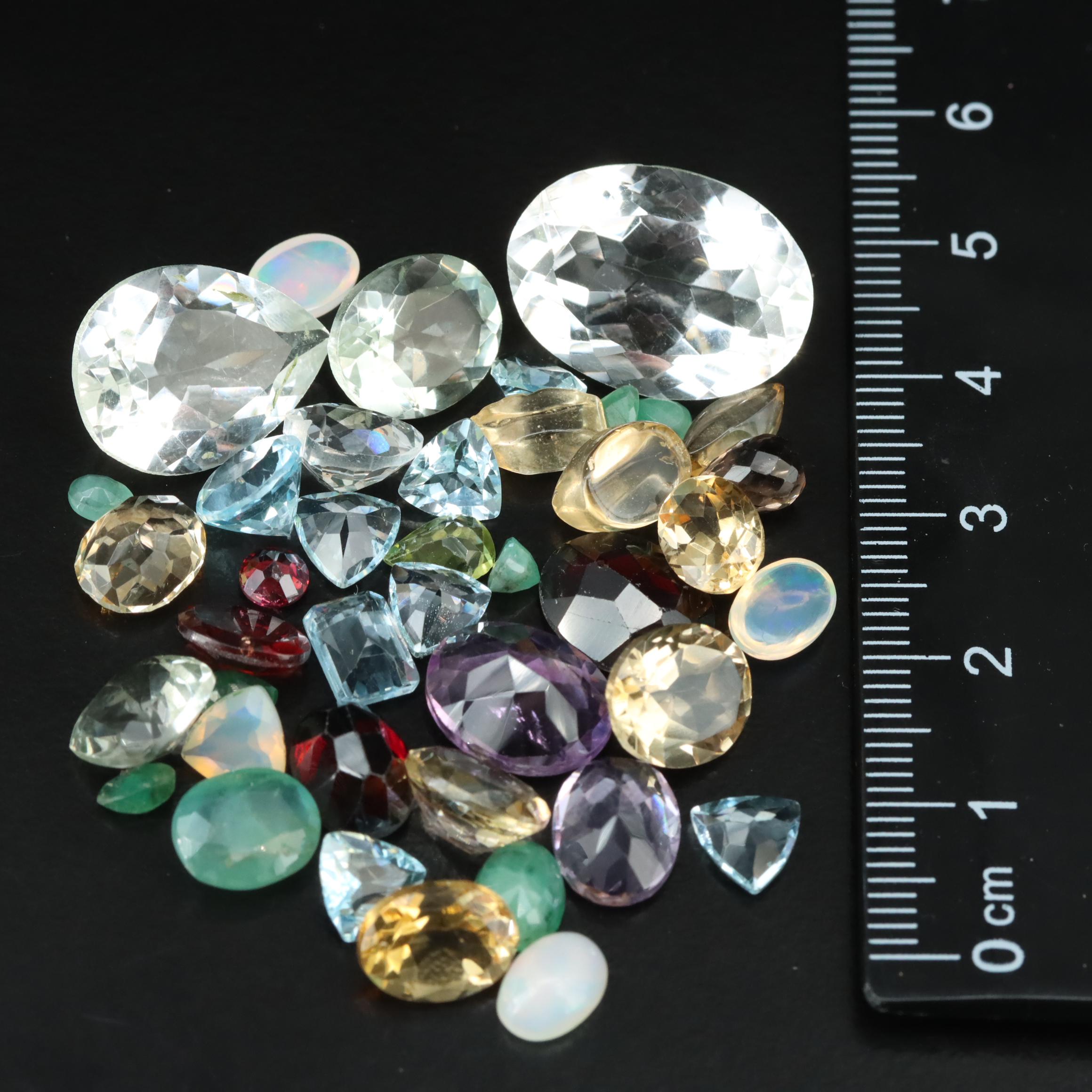 Loose 68.53 CTW Citrine, Blue Topaz, Emerald, and Gemstone Lot
