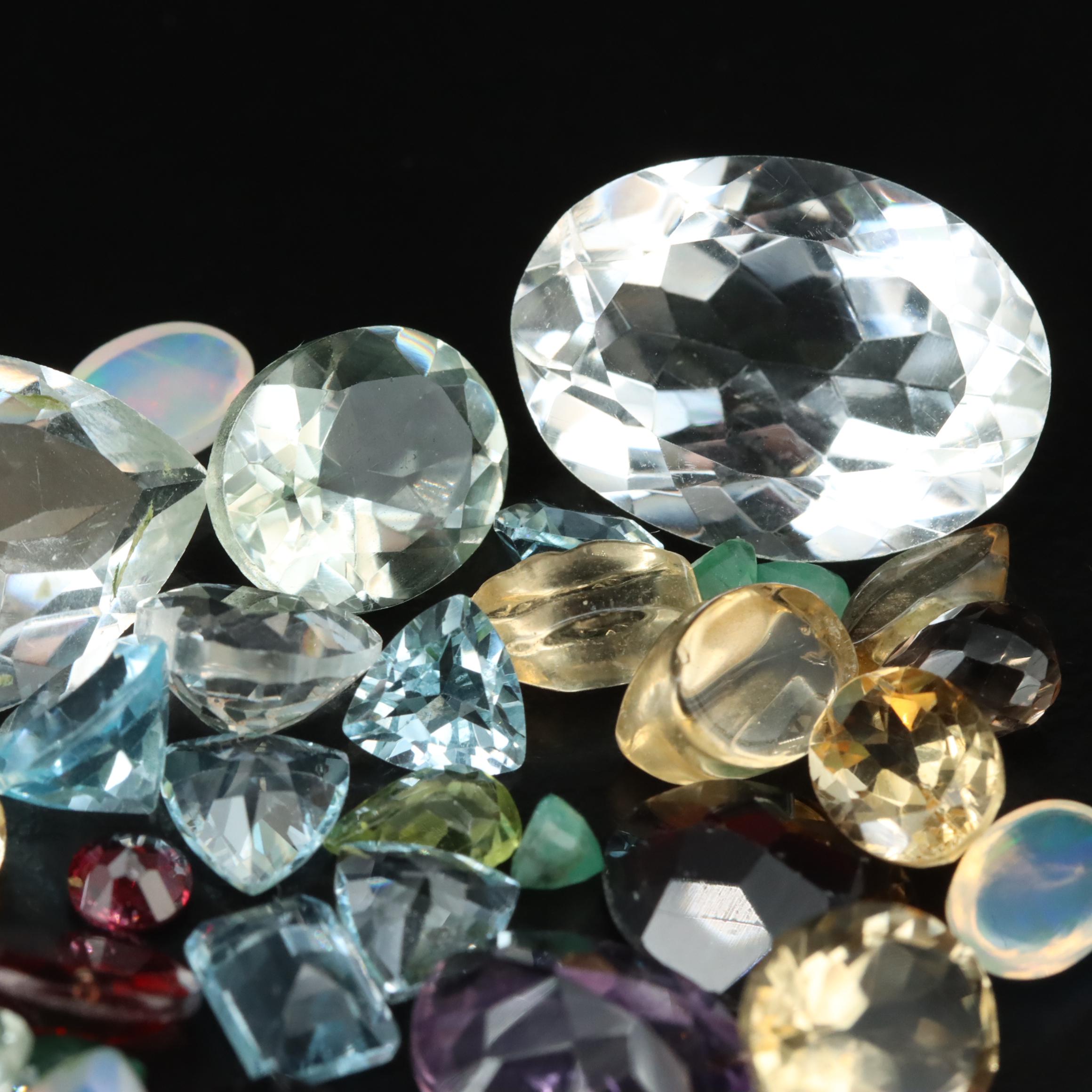 Loose 68.53 CTW Citrine, Blue Topaz, Emerald, and Gemstone Lot