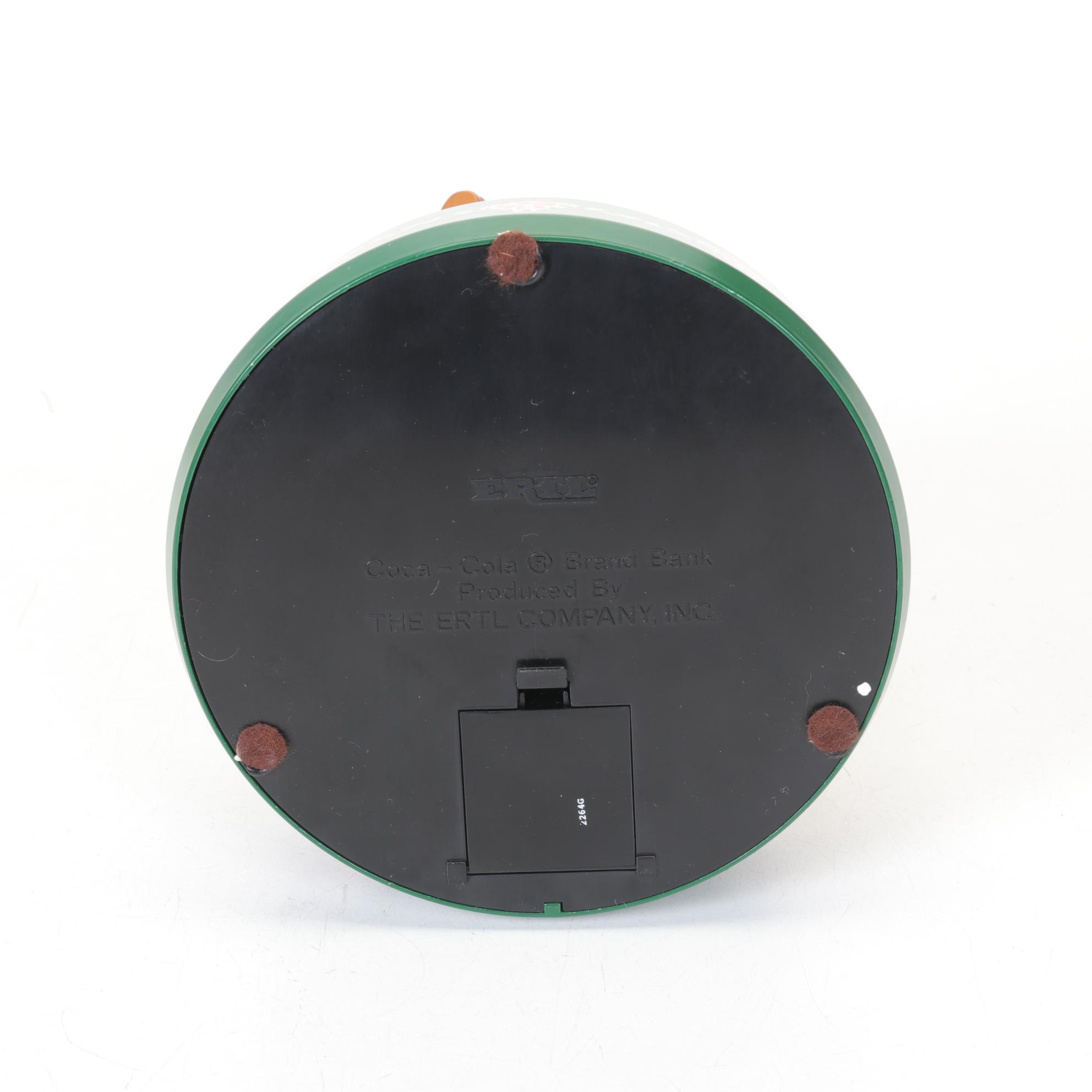 Coca-Cola Christmas Decorations with Three Banks, a Figurine, and a Bobblehead