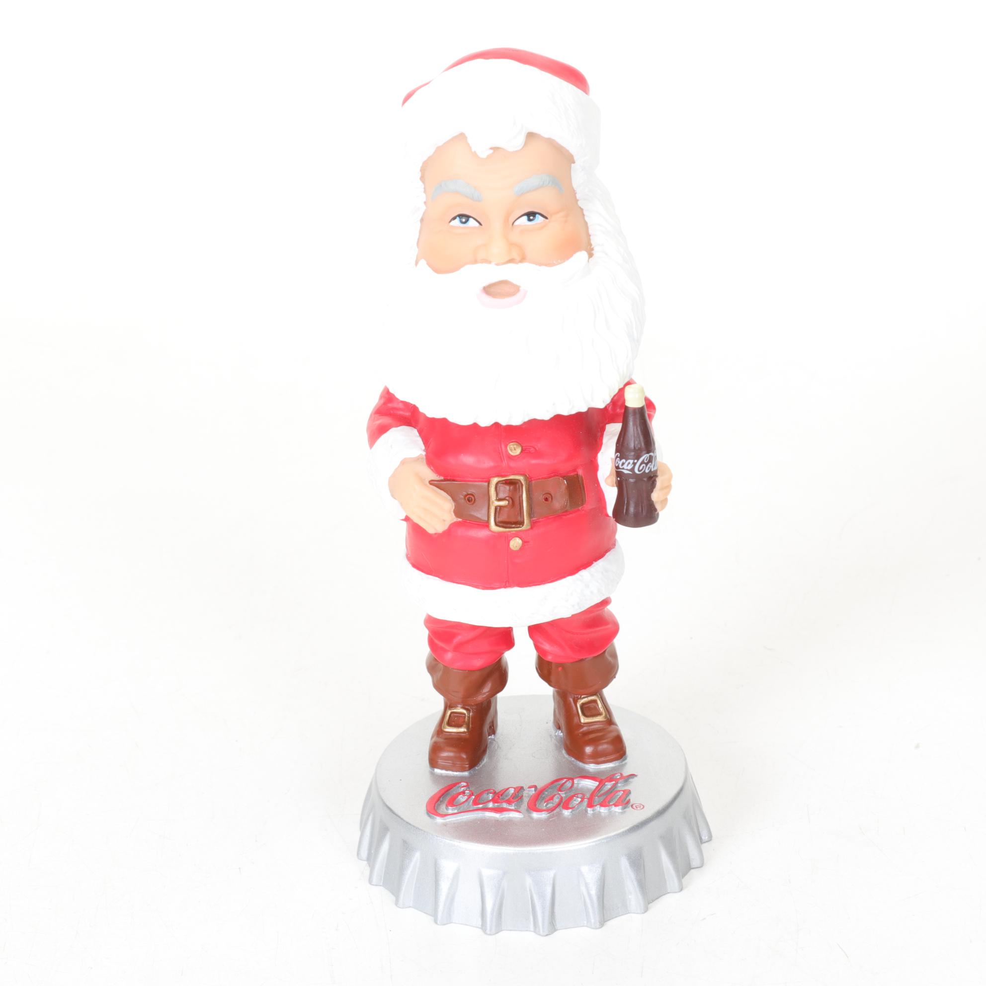 Coca-Cola Christmas Decorations with Three Banks, a Figurine, and a Bobblehead