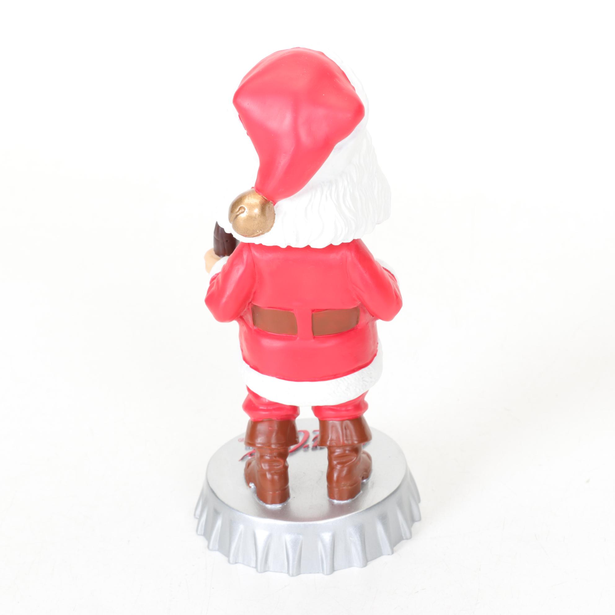 Coca-Cola Christmas Decorations with Three Banks, a Figurine, and a Bobblehead