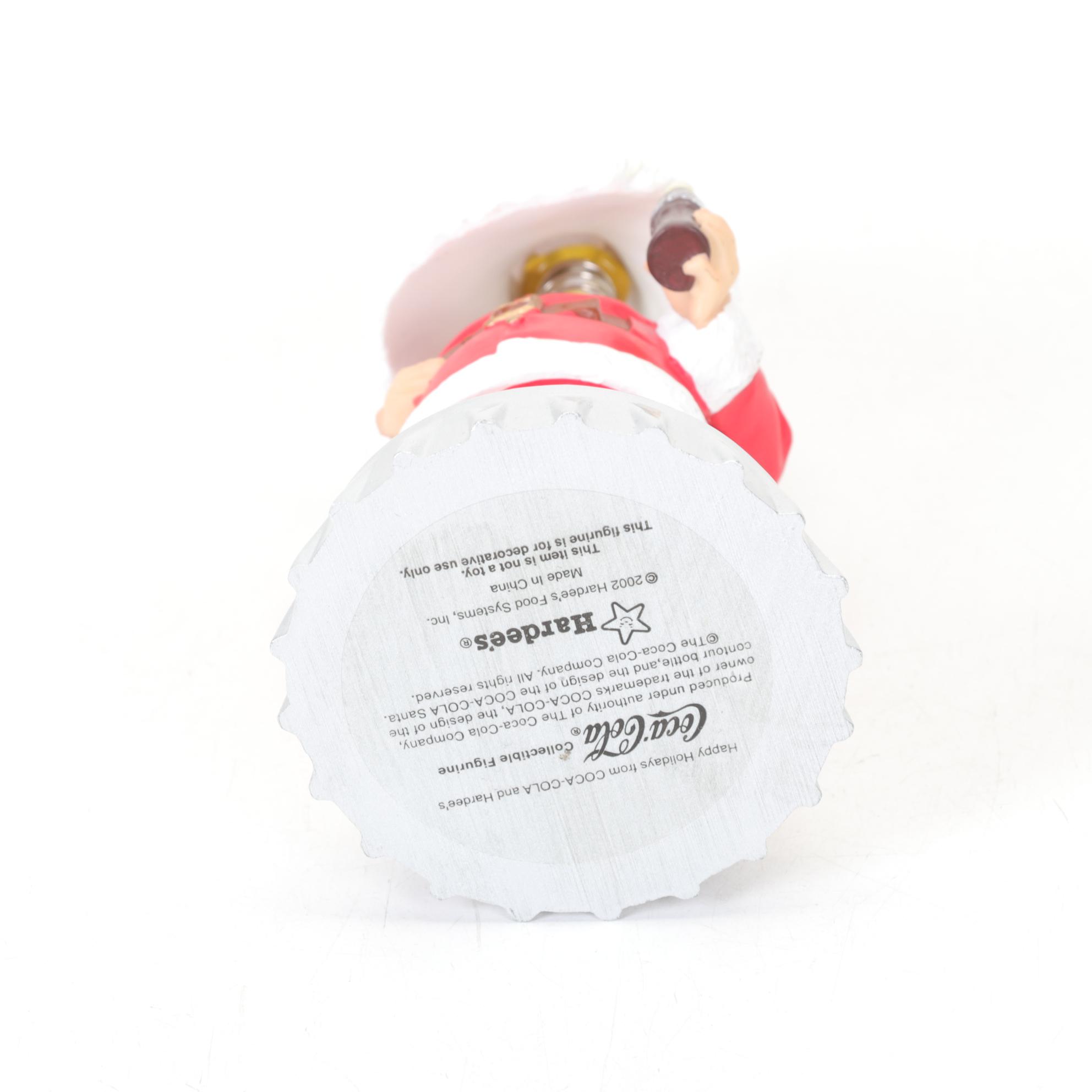 Coca-Cola Christmas Decorations with Three Banks, a Figurine, and a Bobblehead