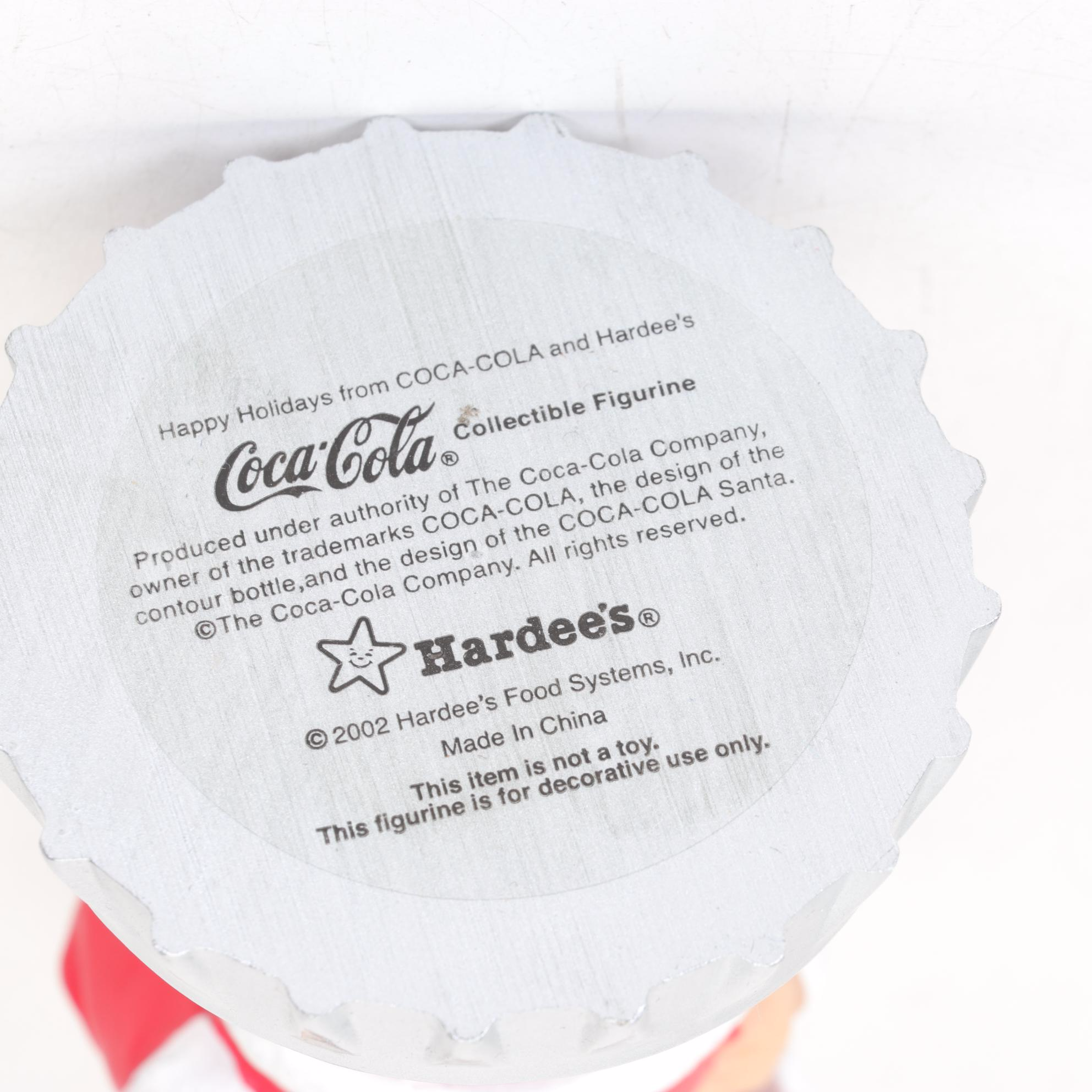 Coca-Cola Christmas Decorations with Three Banks, a Figurine, and a Bobblehead