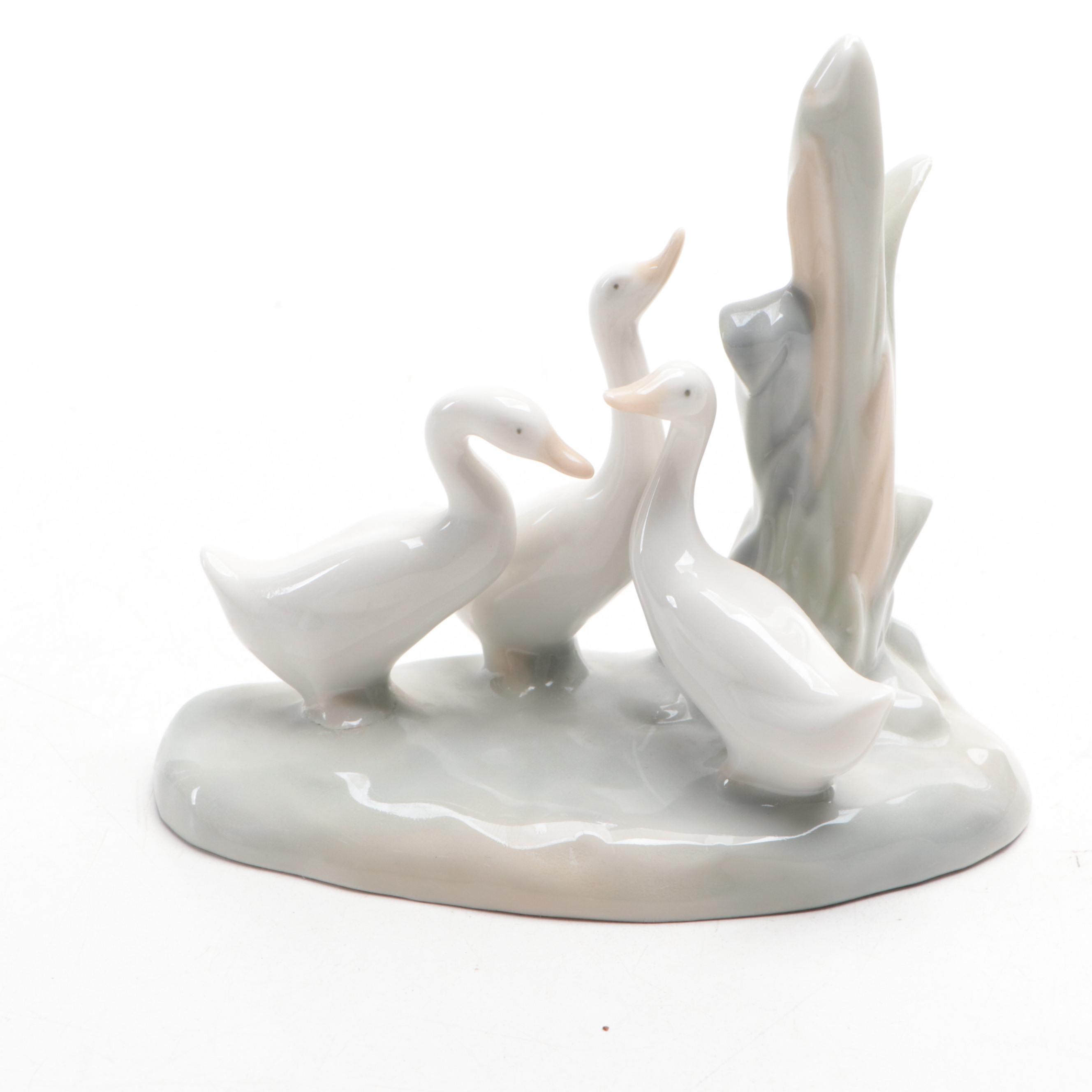 Lladró "Girl Holding Pig" with Nao by Lladró "April Showers" and Geese Figurines