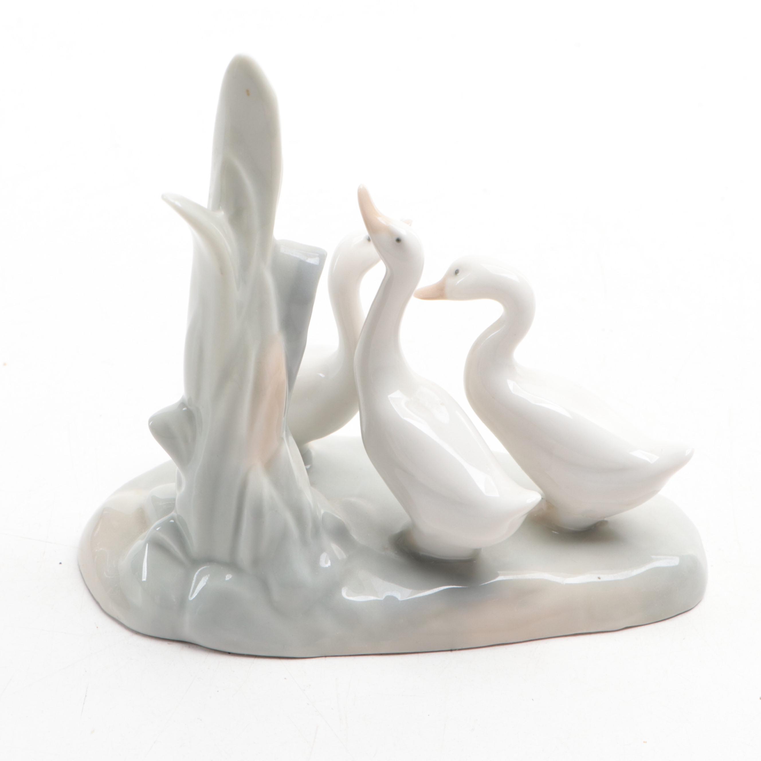 Lladró "Girl Holding Pig" with Nao by Lladró "April Showers" and Geese Figurines