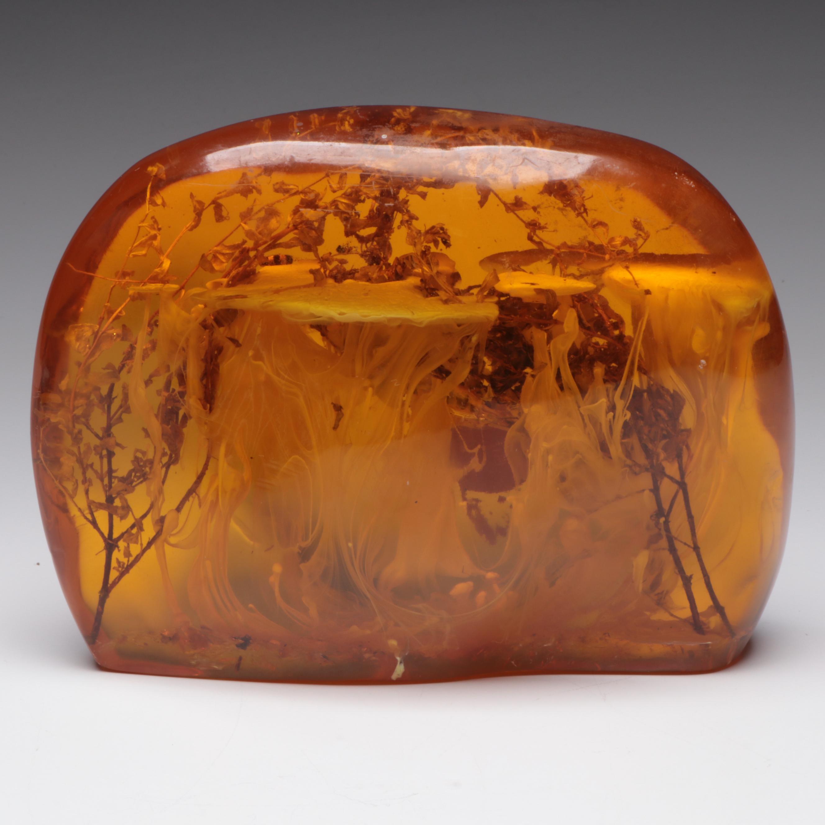 Amber Colored Resin Sculpture with Entrapped Plant Specimens
