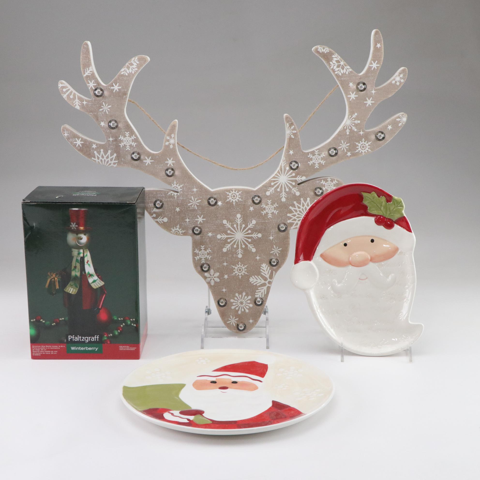 Metal Snowman Wine Bottle Holder, Reindeer Wall Hanging, & Ceramic Santa Plates
