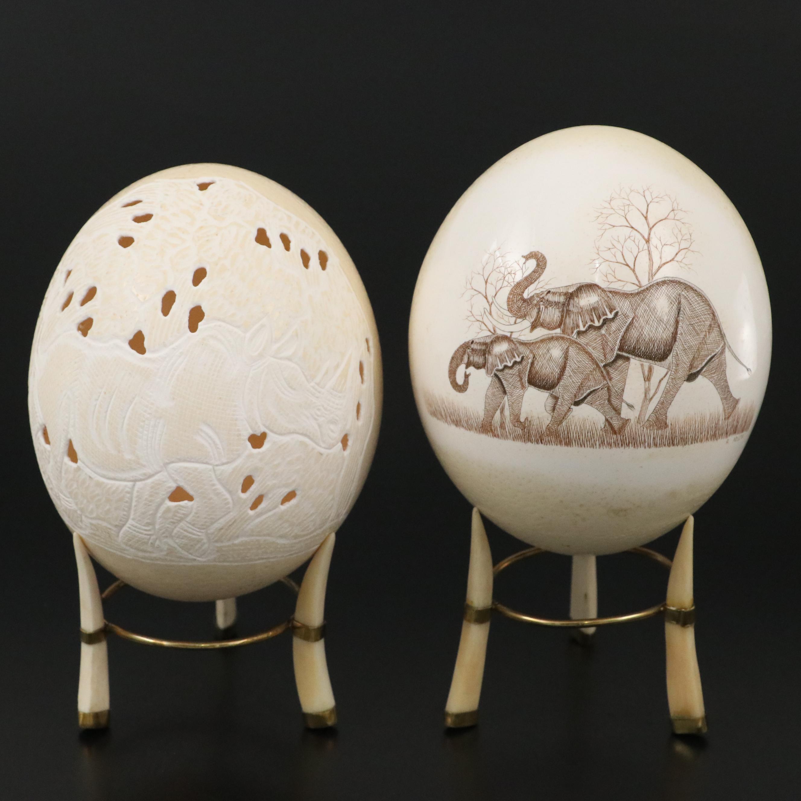 Hand-Carved Ostrich Eggs with Scrimshaw Elephant and Rhino Motifs on Bone Stands